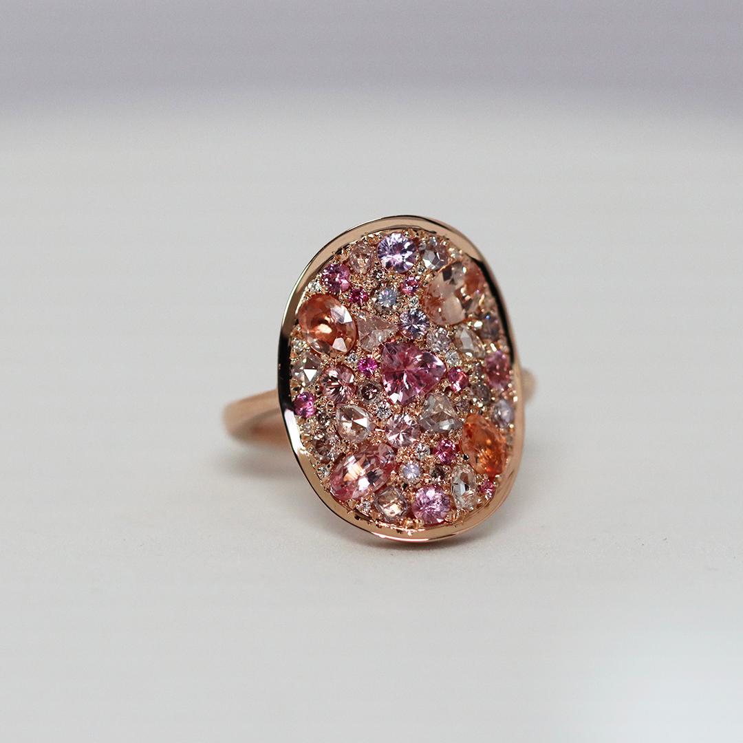 Blushing lotus-pink hues come to life in this one-of-a-kind creation, Pink Poetry. Crafted in 18K rose gold, this ring radiates warmth and elegance with its unique curved design that hugs your fingers contour.

Handmade in Belgium, with no casting