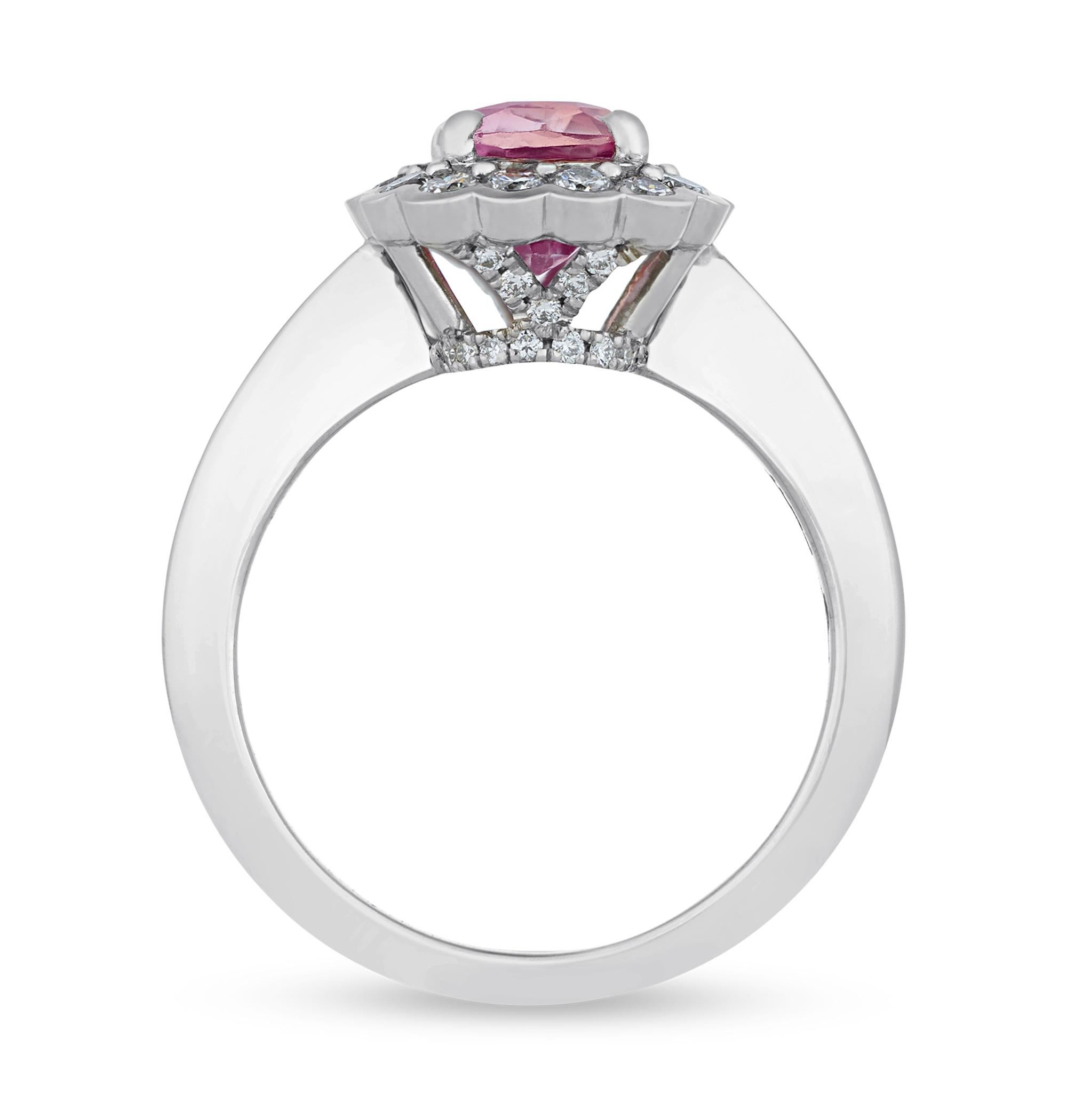 The unique color of the Padparadscha sapphire is perfectly showcased in this 2.06-carat ring. The captivating jewel displays the superb orangy-pink color for which these stones are so coveted. The cushion-cut sapphire is certified by the Gemological