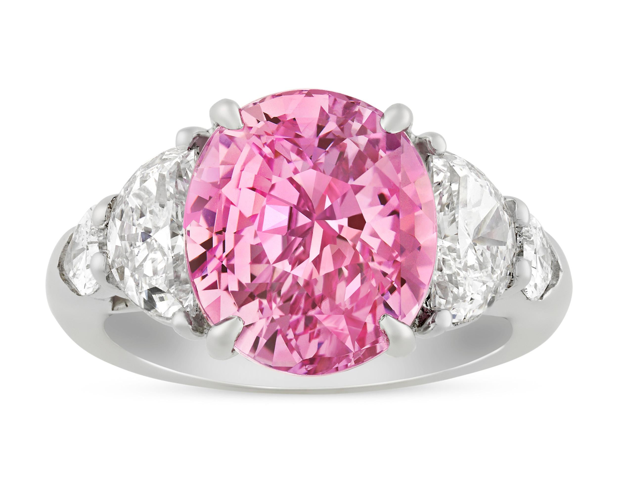 This ring features a monumental Padparadscha sapphire weighing 8.45 carats. Padparadscha sapphires derive their name from the Singhalese word for “aquatic lotus blossom,” as their pinkish-orange hue mimics that of the popular flowers. This example