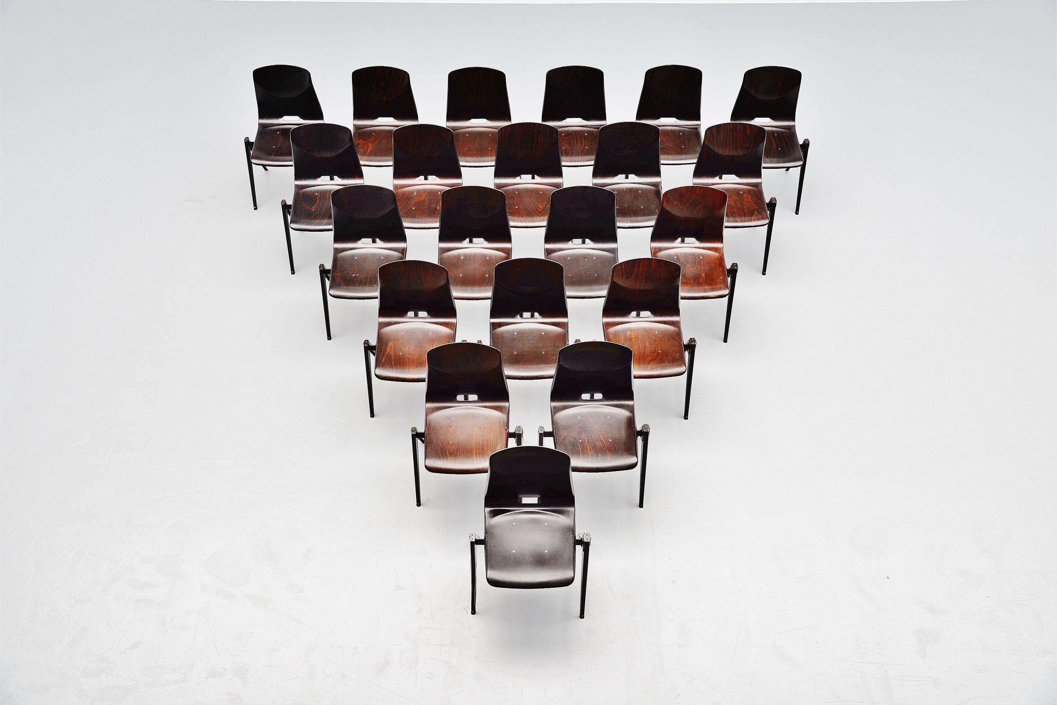 Large set of 22 stacking chairs model S22 designed and manufactured by Pagholz, Germany 1970. We have more chairs available in other colors too, upon request. These chairs have dark brown metal compass shaped v structured frames and really dark