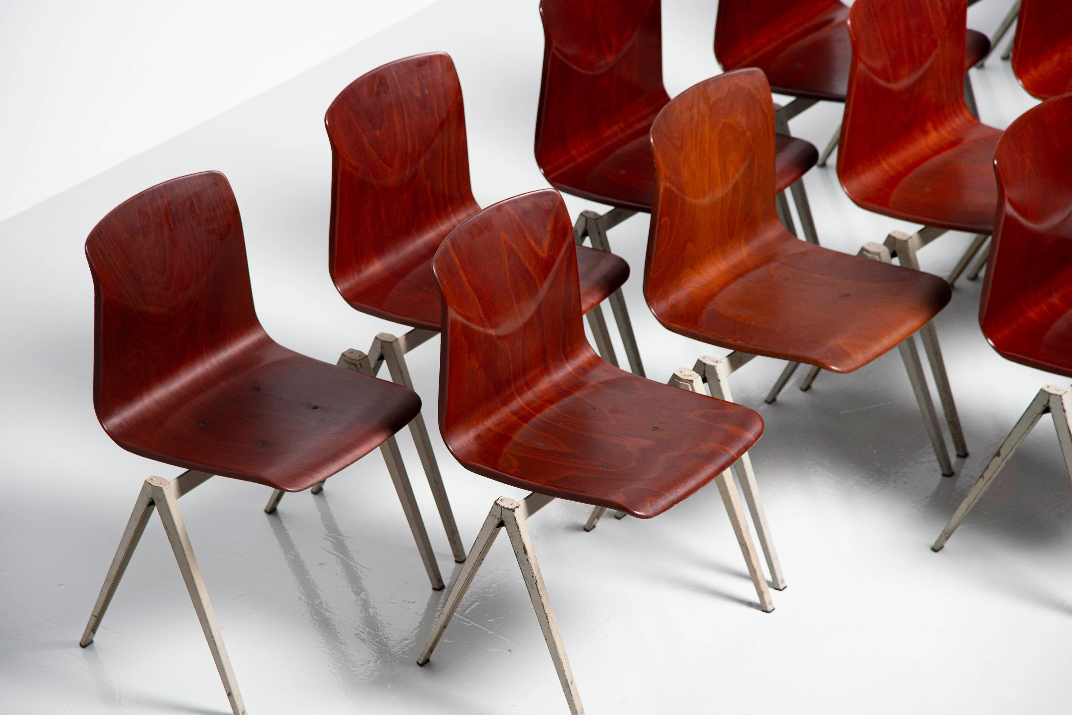 Large set of 16 stacking chairs model S22 designed and manufactured by Pagholz, Germany 1970. We have more chairs available in other colors too if wanted. These chairs have grey metal compass shaped v structured frames and red brown pressed wooden