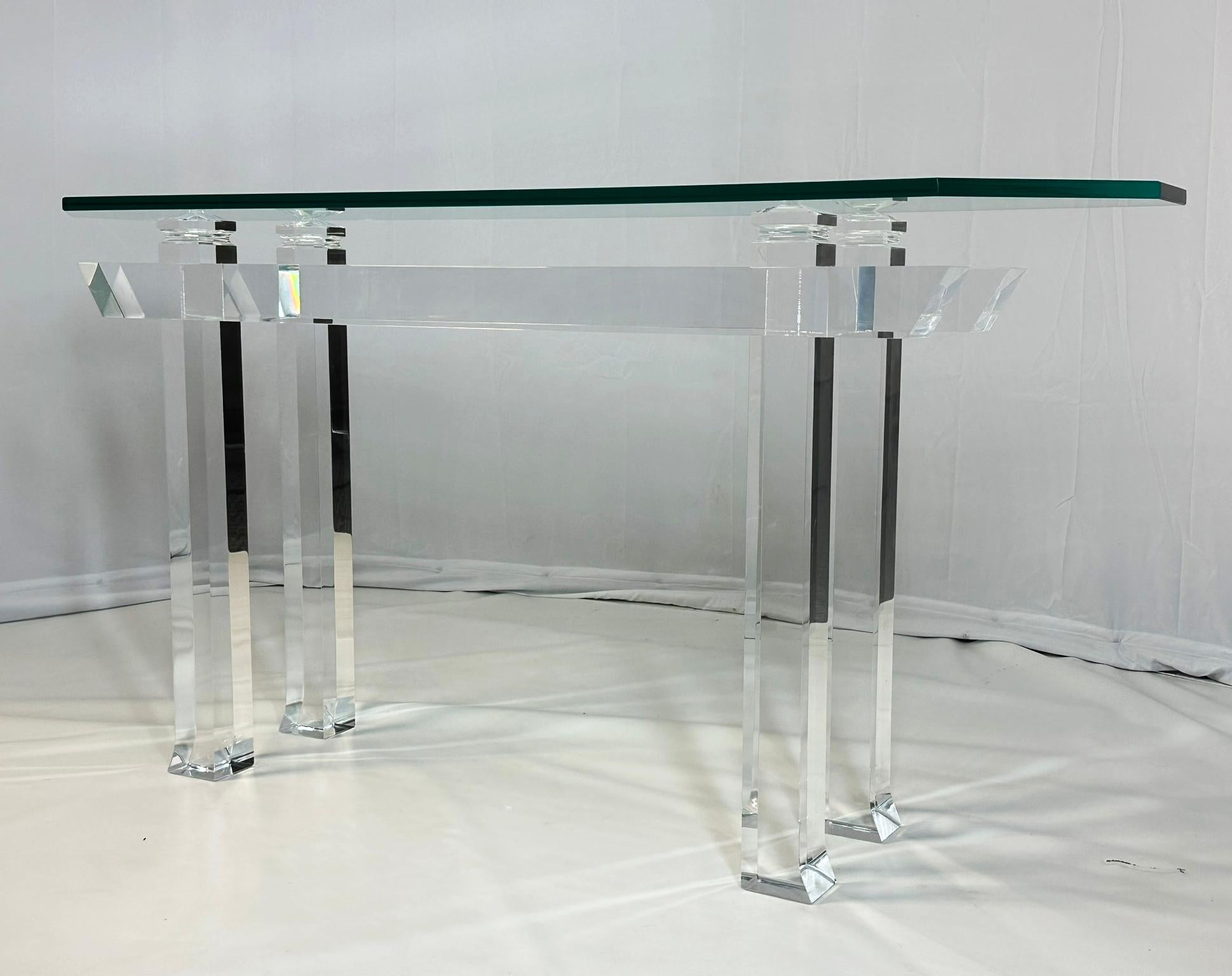 Pagoda console table designed and manufactured in the USA by Charles Hollis Jones in the mid to late 1970s.
 
The piece is made in solid Lucite topped with a rectangular glass top.
 
Measurements:
 64 inches wide x 14 inches deep x 32 inches high. 
