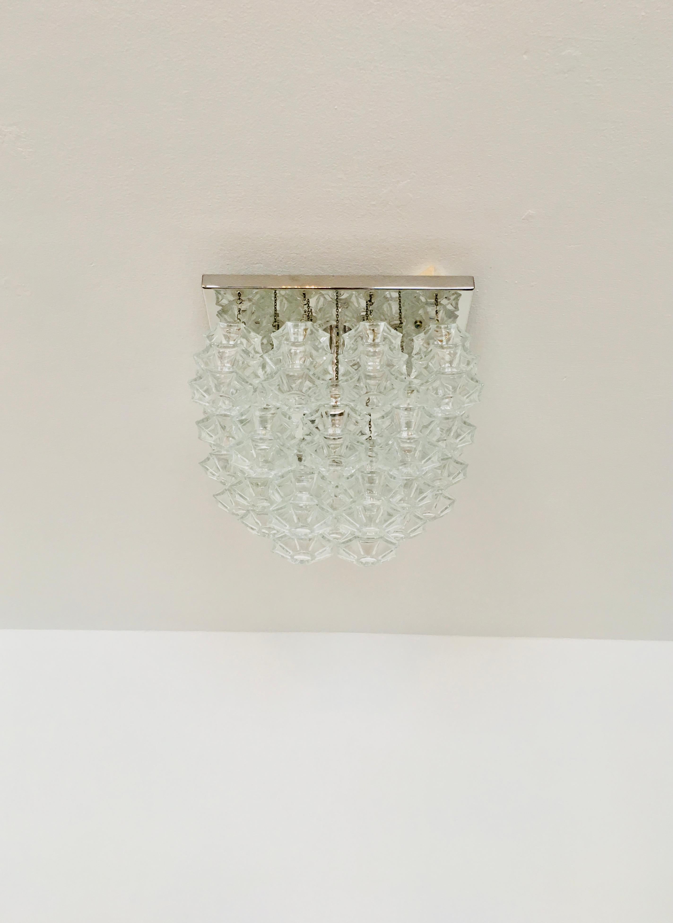 Wonderful ceiling lamp from the 1960s.
The 24 beautifully shaped Murano glass elements create an impressive, sparkling play of light.
Very rare version with 3 rows.
Very high-quality workmanship and a real eye-catcher for every home.

Design: