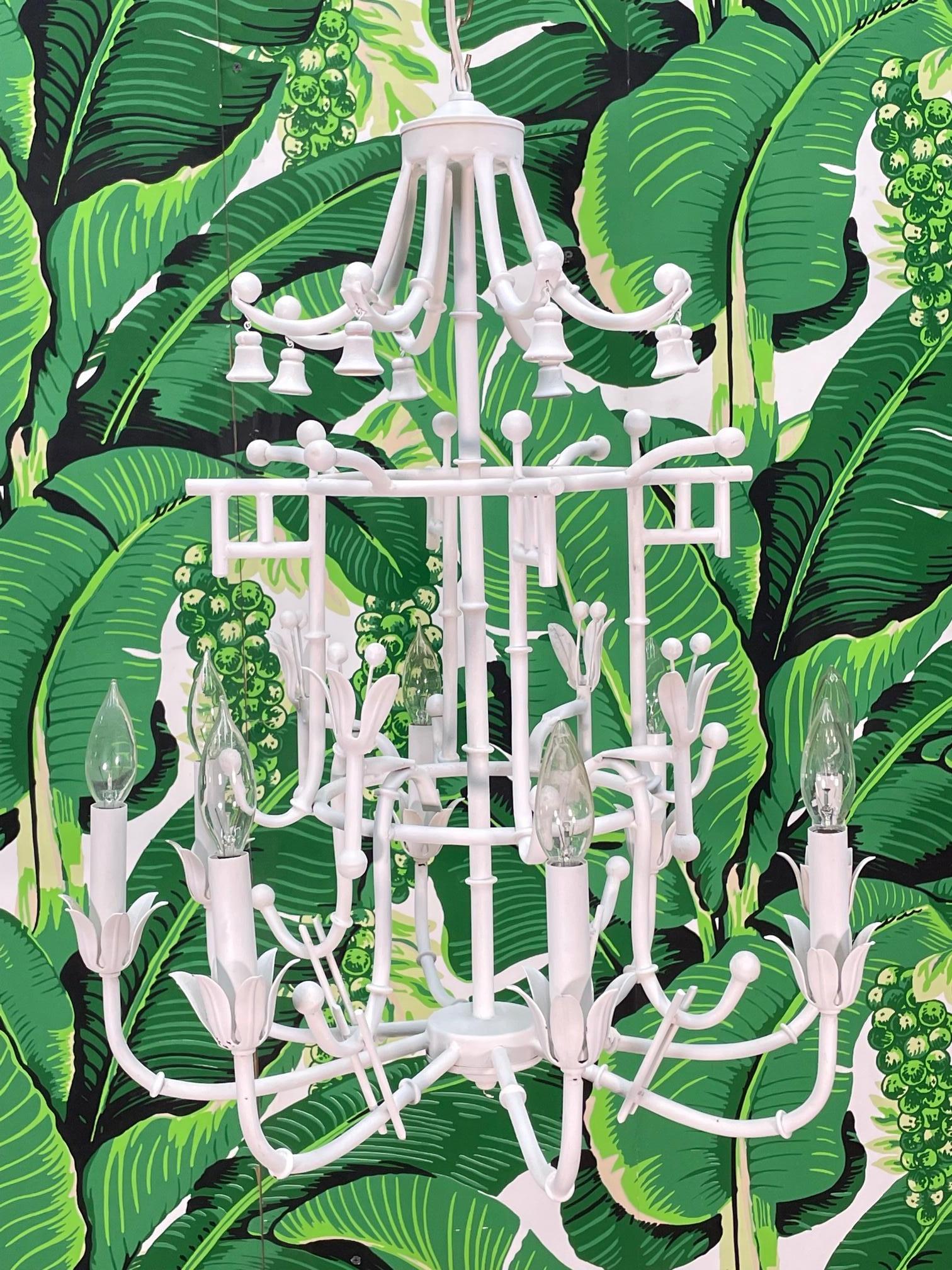Vintage metal pagoda chandelier features a metal faux bamboo frame with wood-carved bells. Good condition with minor imperfections consistent with age, see photos for condition details.

