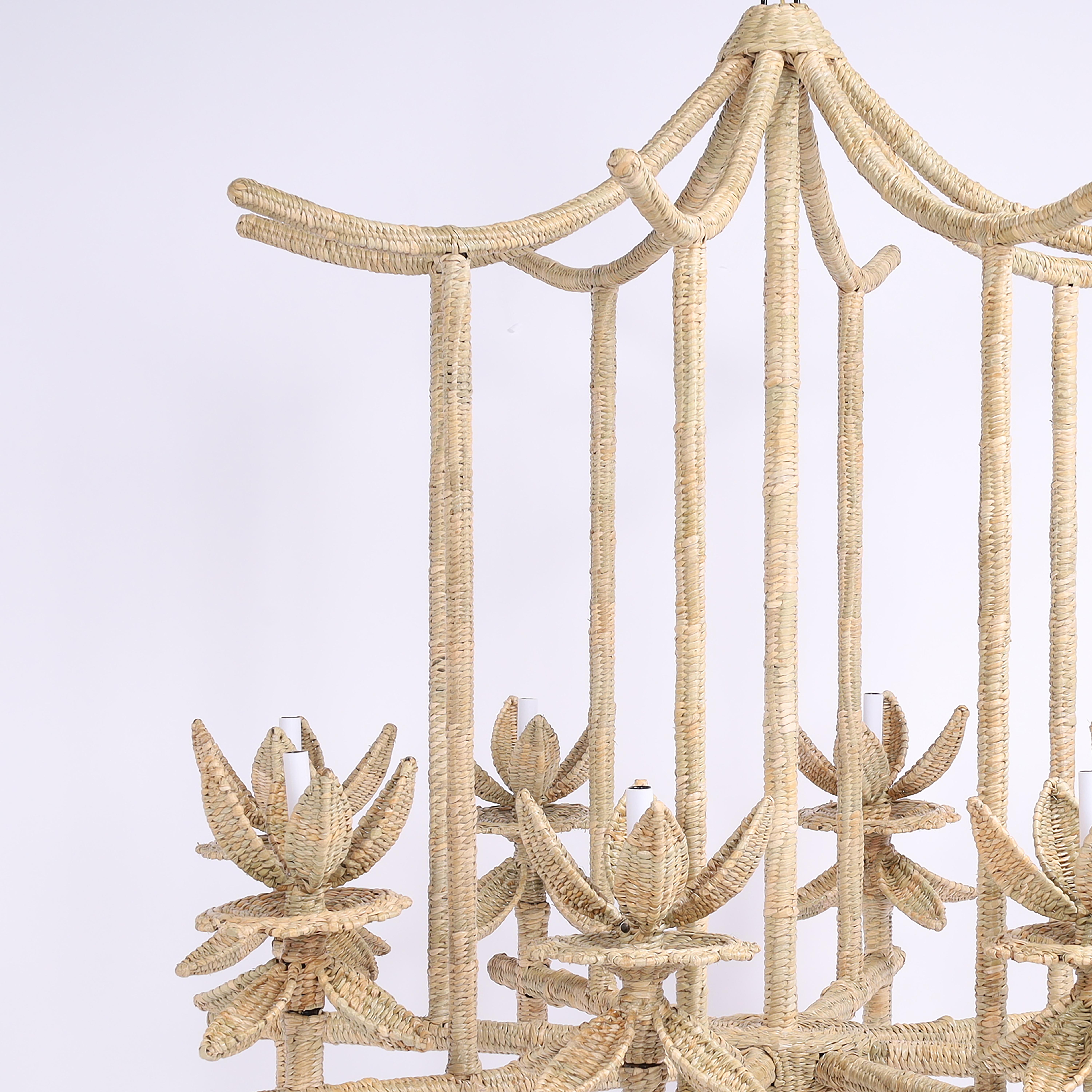 Impressive large Chinoiserie eight light chandelier handcrafted with a metal frame expertly wrapped in reed in an alluring pagoda form with lotus leaf candle cups, designed and manufactured exclusively by FS Henemader Antiques.