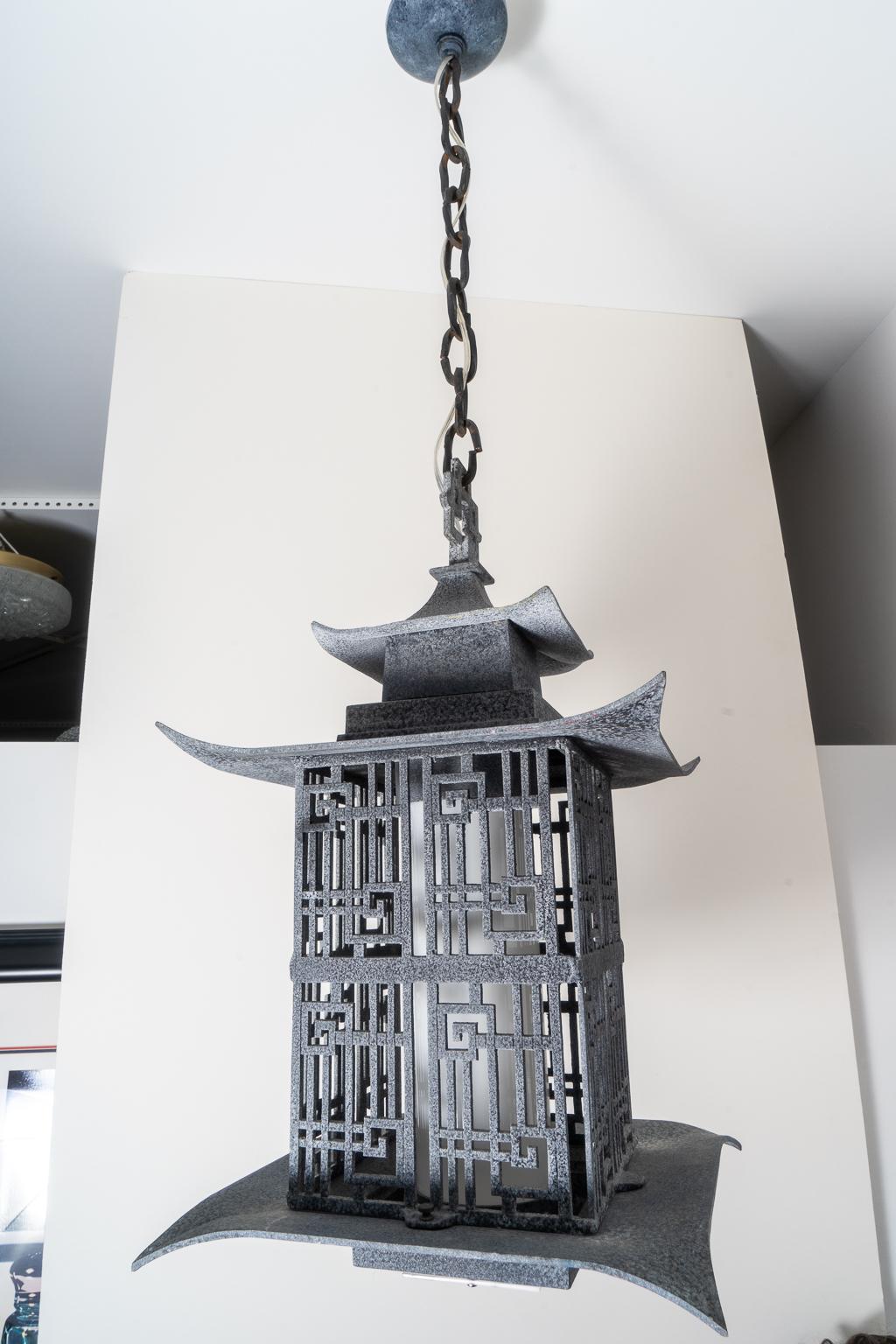 This stylish and chic charcoal gray colored 1960s pagoda lantern chandelier was acquired from a Palm Beach estate and has been professionally rewired. 

Note: The interior globe is white glass and the bottom panel is clear Lucite (see last three