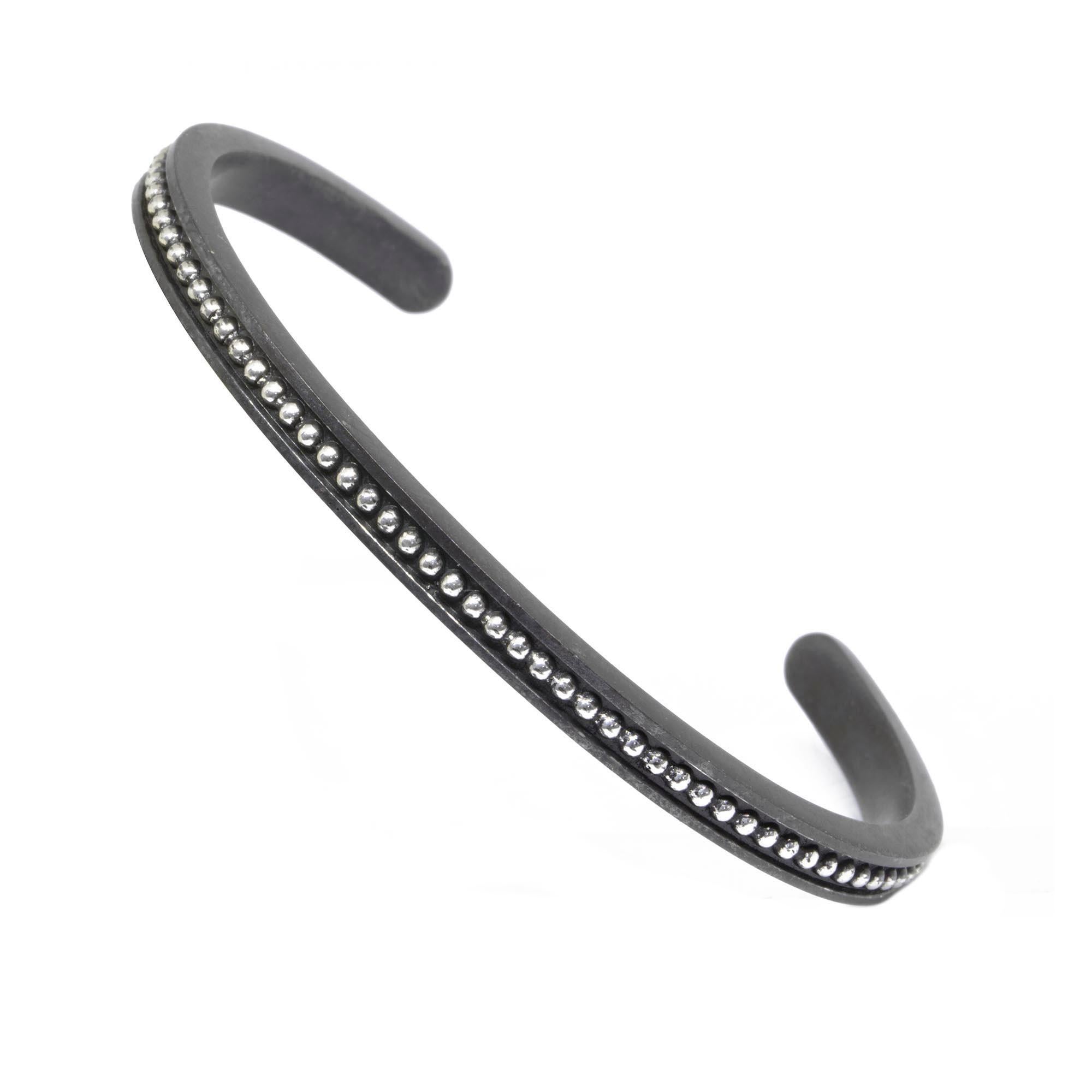 Start your Nina Nguyen collection here. A jewelry wardrobe essential to anchor any bracelet stack, this slender cuff pairs blackened silver with lighter, lustrous sliver granules. Combining a classic design with chic details and a neutral metallic
