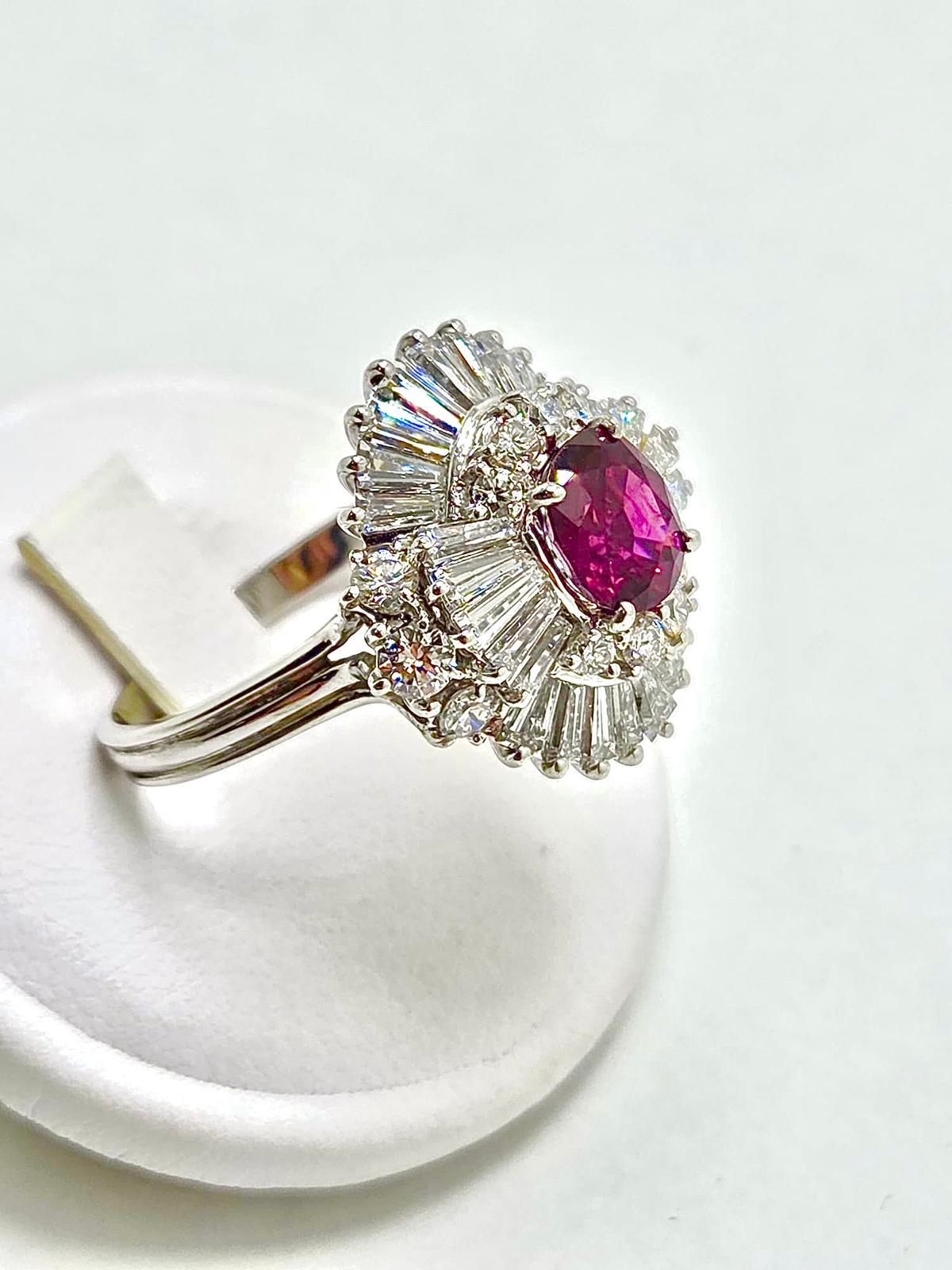 A striking Pagoda-style ring, centered with a rare natural Burmese ruby of 1.80 carats, displaying a vivid purplish-red hue of exceptional beauty. Surrounding the ruby is a magnificent double halo of diamonds totaling approximately 3 carats, all