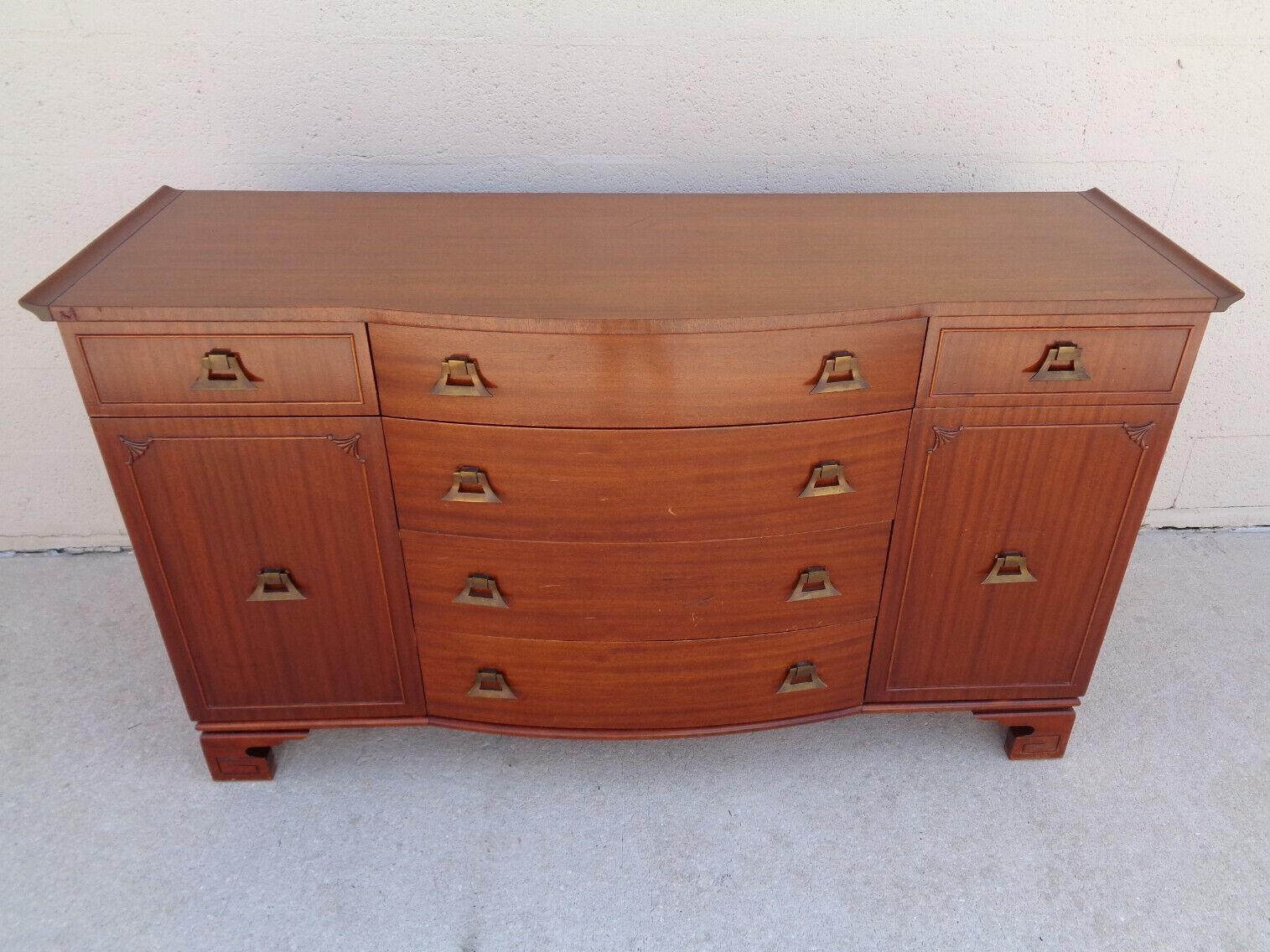Vintage James Mont style pagoda form sideboard buffet manufactured by RWay Northern Furniture Company. Sideboard has Ming style feet with a Greek Key motif and original distinctive solid brass decorative pulls. Ample room to store items in six
