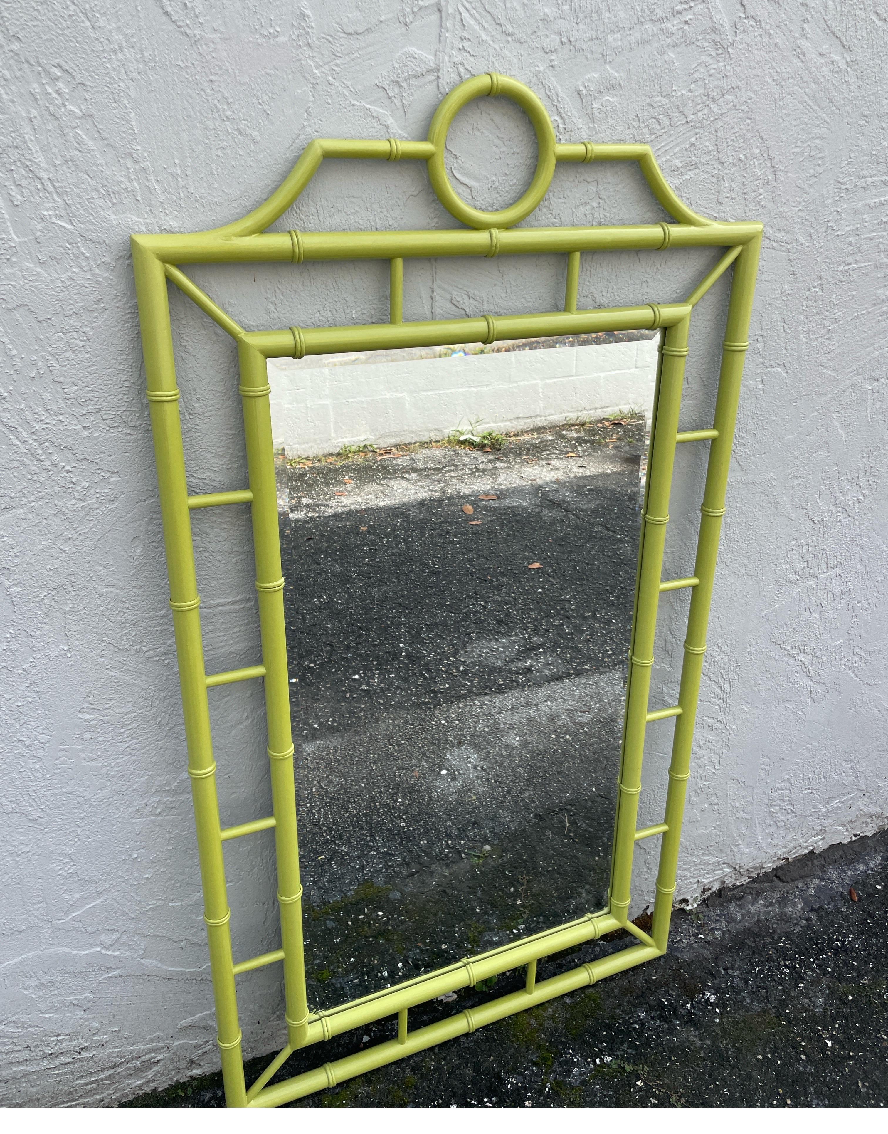 Large Chinoiserie Pagoda style mirror in a lacquered Lime green finish.  The mirror plate is beveled.