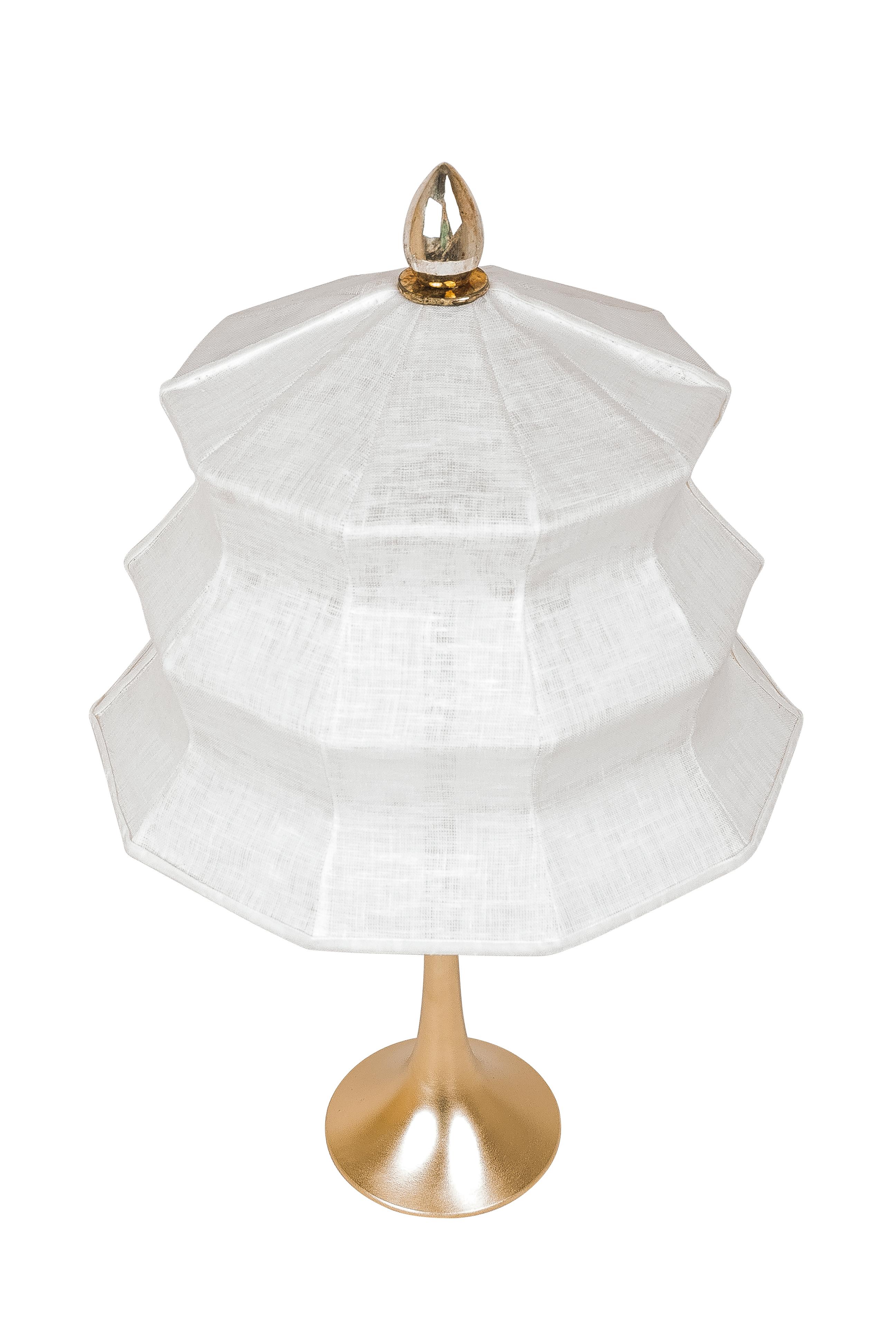 This table lamp is a contemporary piece, made entirely by hand in Tuscany Italy, 100% of Italian origin. 

Inspired by the eastern Pagoda temple, Sabrina masterfully combines the geometric lines of the lampshade with the smooth, sinuous curve of the