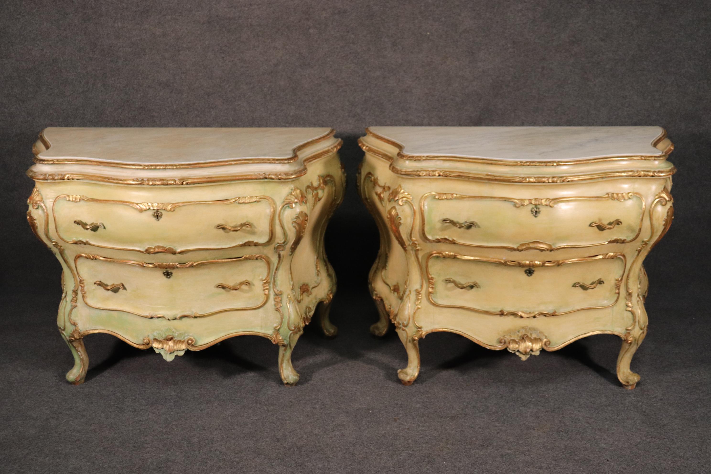 This is a fine and rare pair of Italian made rococo commodes. The commodes date to the 1930s and have a soft crème painted finish with gilded highlights. The design, styling and execution of these pieces are very well done. They measure: 46 wide x