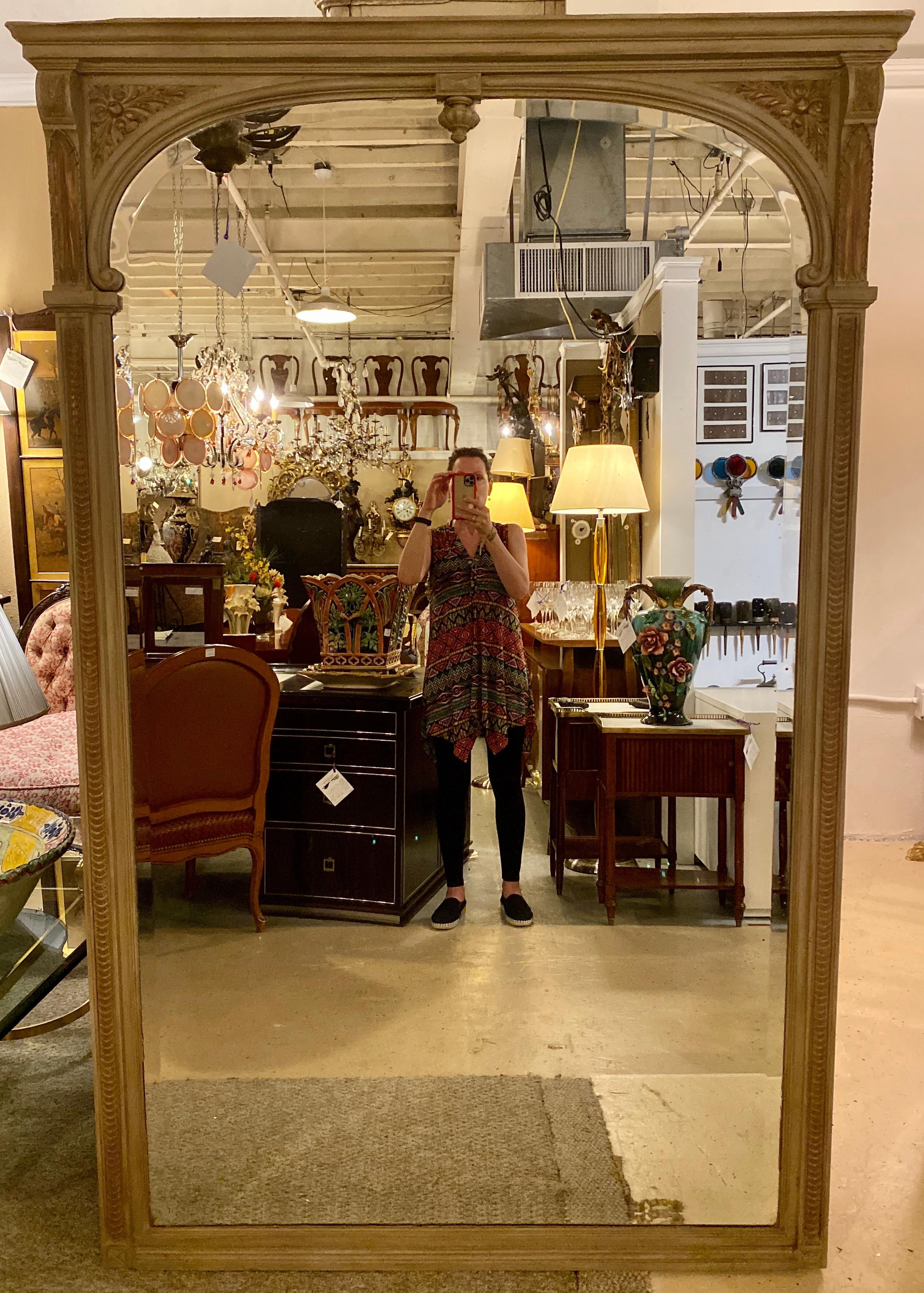Paint decorated beveled floor or over the mantel (fireplace) mirror. Monumental. This is a very large and palatial carved hand painted Swedish style floor or over the mantel (fireplace) mirror. The beveled inset mirror on a finely carved and