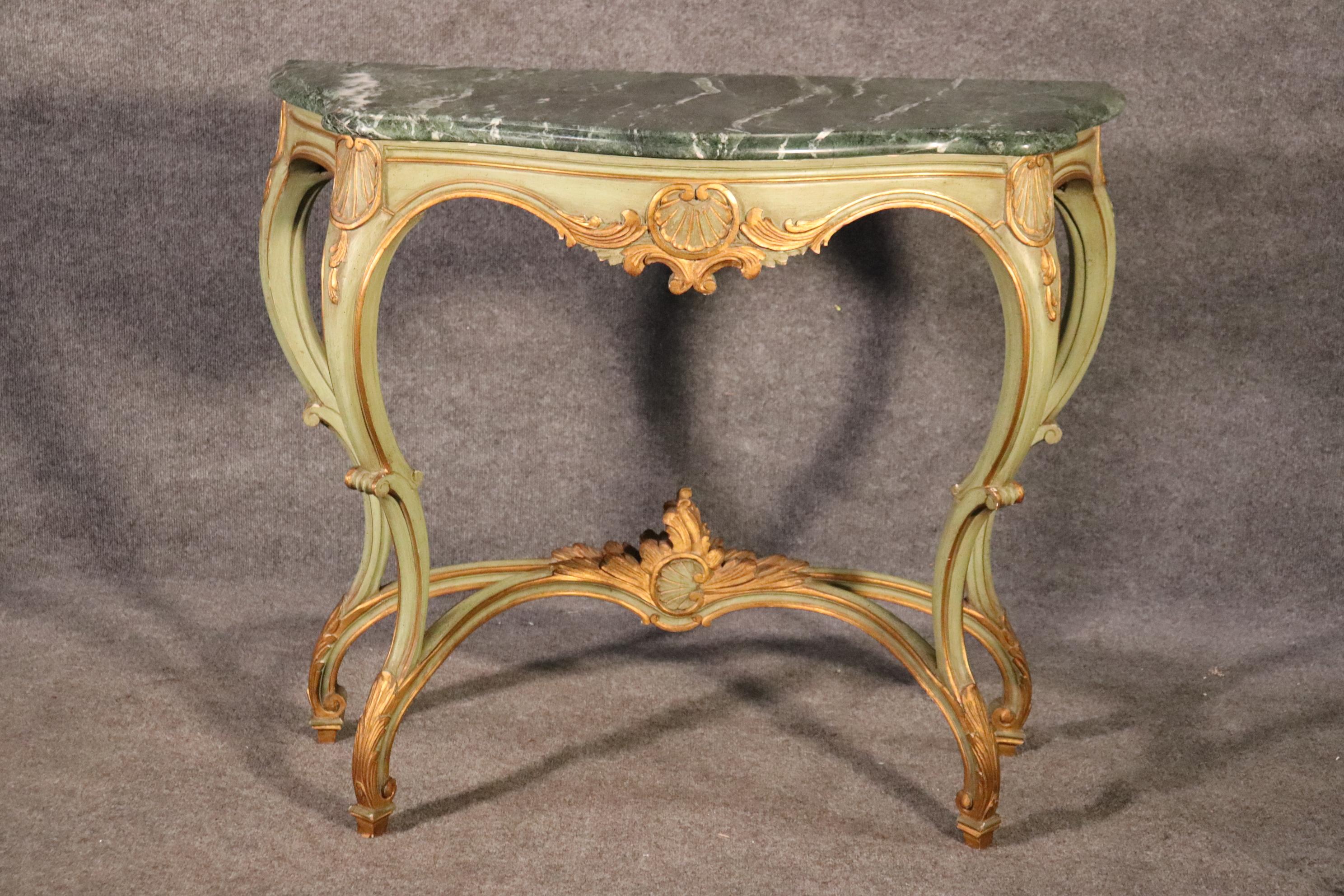 This is a gorgeous French Louis XV console table with a great painted finish and an equally beautiful Verdi marble top. The table measures 41 wide x 17 deep x 35 tall. The table is in good vintage condition.