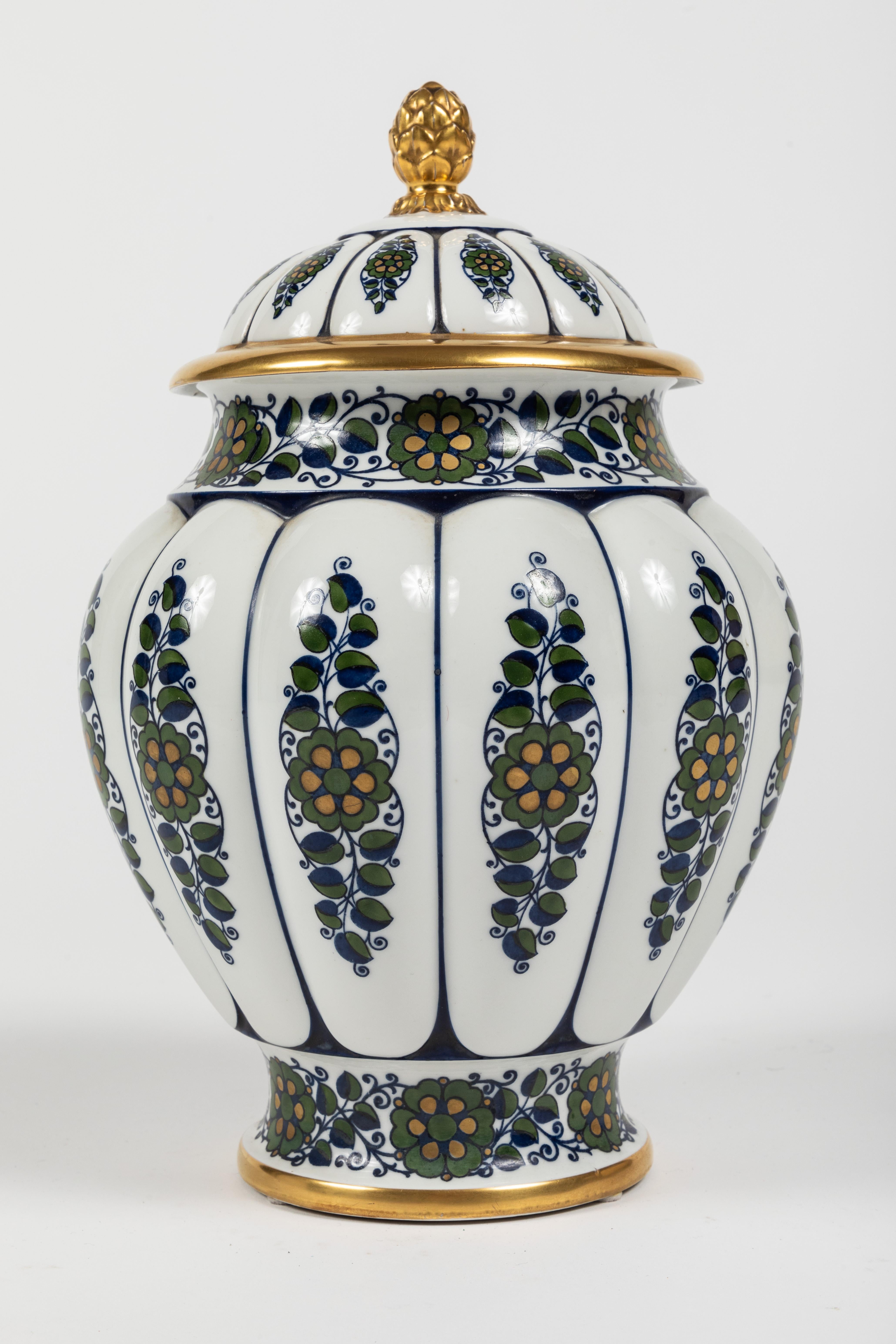 A wonderful lidded urn with blue and green floral decoration and finished with gilt gold accents by Krautheim China. After researching it appears this mark dates to around the turn of the century. The style would also indicate a nod to the turn of