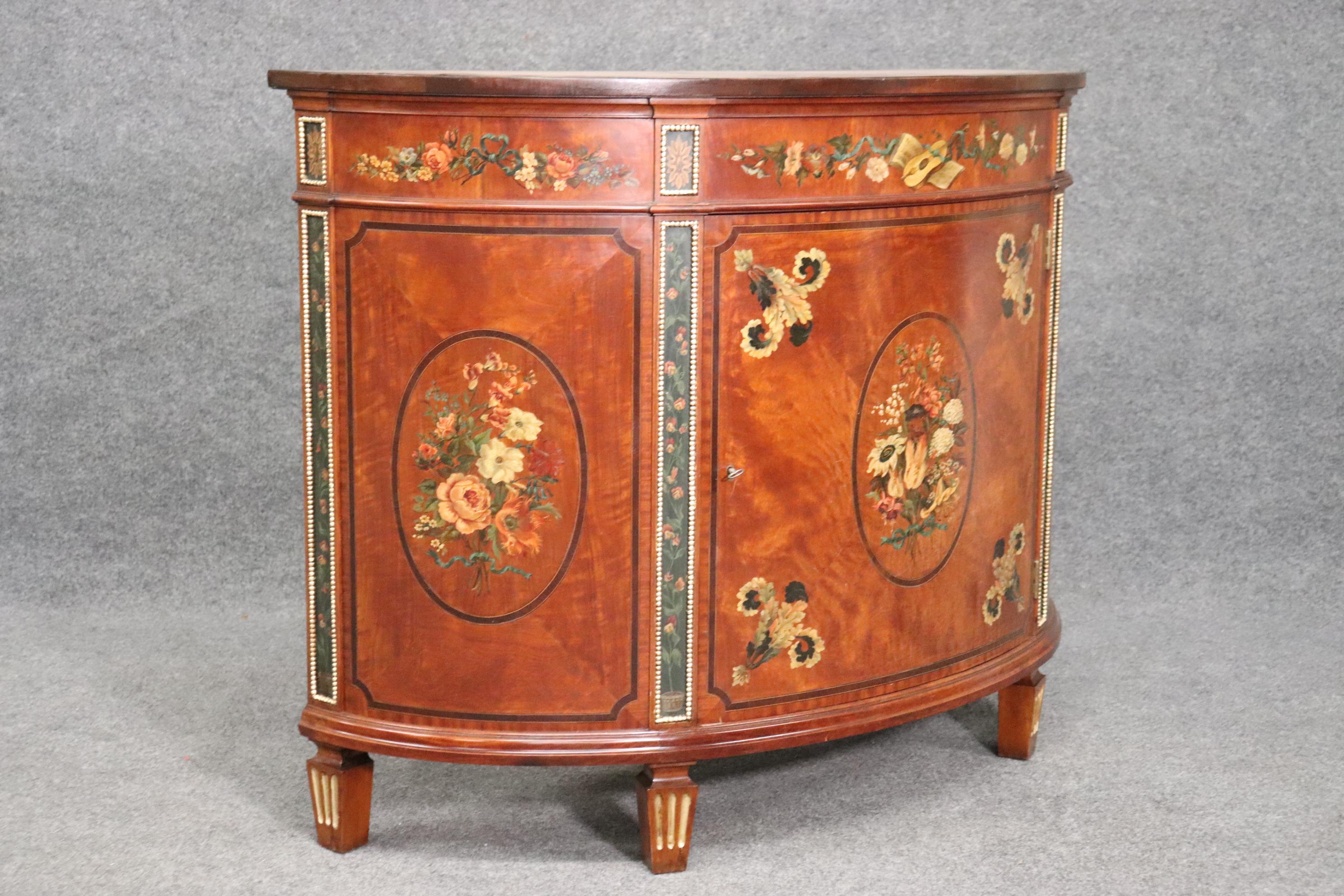 This is a gorgeous hand-painted antique Adams commode. The commode is made of solid satinwood which is rare enough, but the simple lines and design and gorgeous paint decoration adds quite a bit of character. The commode does have signs of weard and