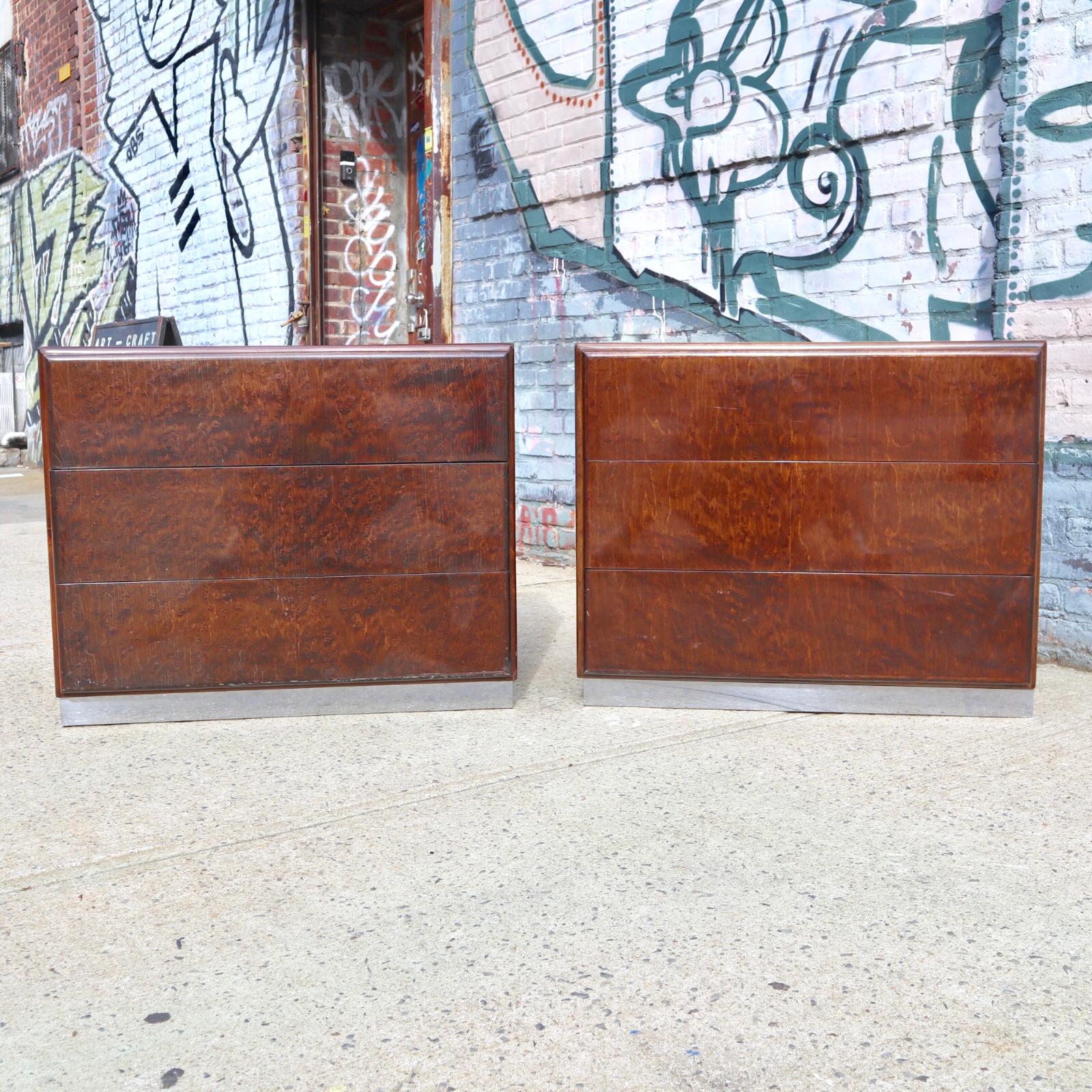 Swanky set of burl wood dressers by Milo Baughman for Thayer Coggin. Each dresser features 3 drawers that operate smoothly. Both signed with maker tag inside top drawer. Brilliant colored wood with highly figured grains. Dressers rest upon