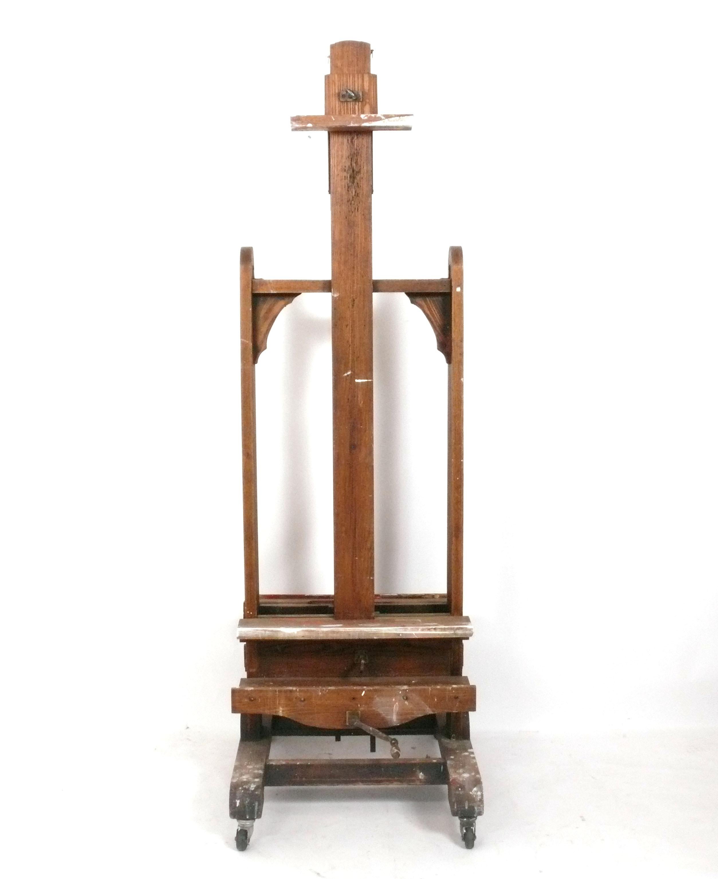 Paint Covered Artist's Double Easel, American, circa 1940s. Rare double sided easel. This piece retains it's wonderful original paint covered patina. It can be used to hold two large paintings or as a flat screen TV stand, with a TV on one side and