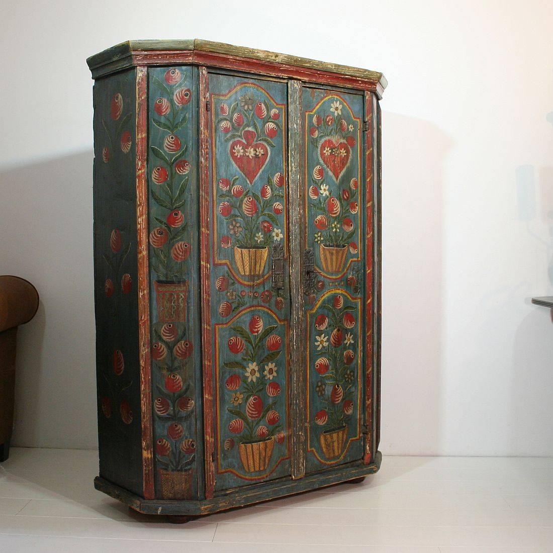 Beautiful painted 18th century French wedding armoire with beautiful painted bouquets, hearts and iron hinges, wood pegs. Alsace, France 18th century, Weathered, small losses and old repairs. Armoire is from the 18th century, paint is from the 19th