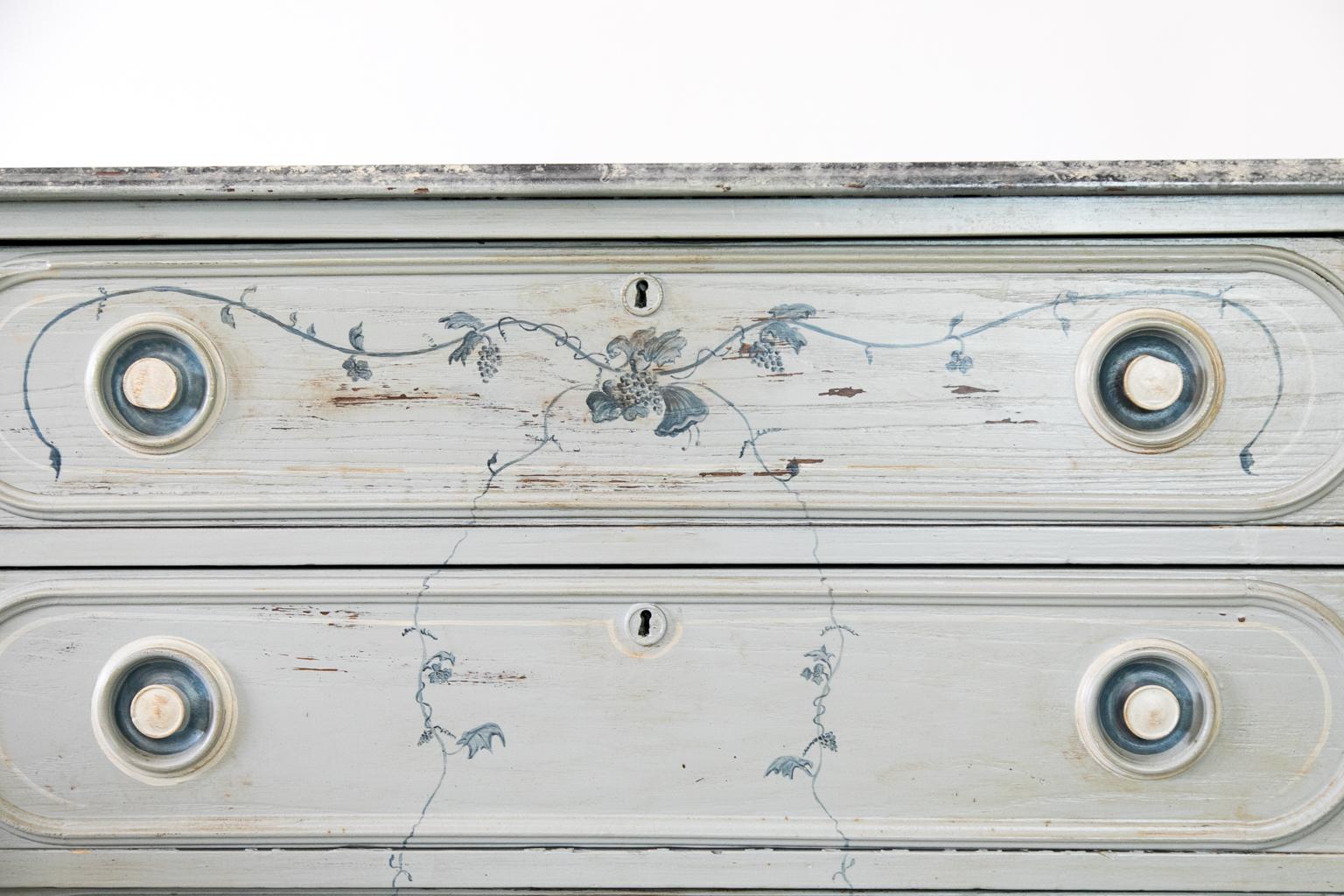 The top of this American painted chest is painted to simulate marble. The drawer fronts and sides are painted in grapevine motif. The sides have recessed panels. The drawer fronts have applied shaped moldings with rounded ends. The original drawer