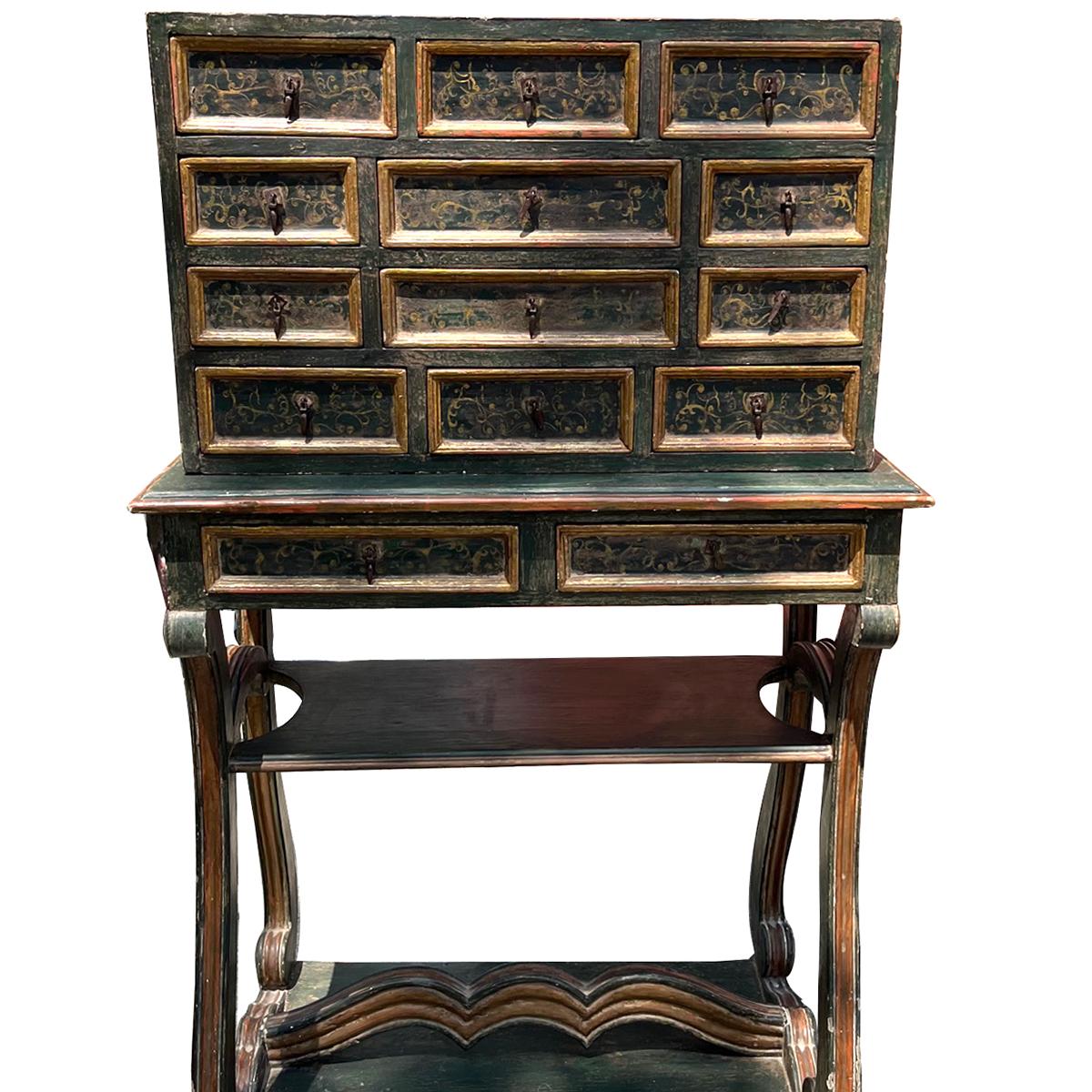 A circa 1920's Spanish painted and gilt wood cabinet with 14 drawers.

Measurements:
Height: 51.5