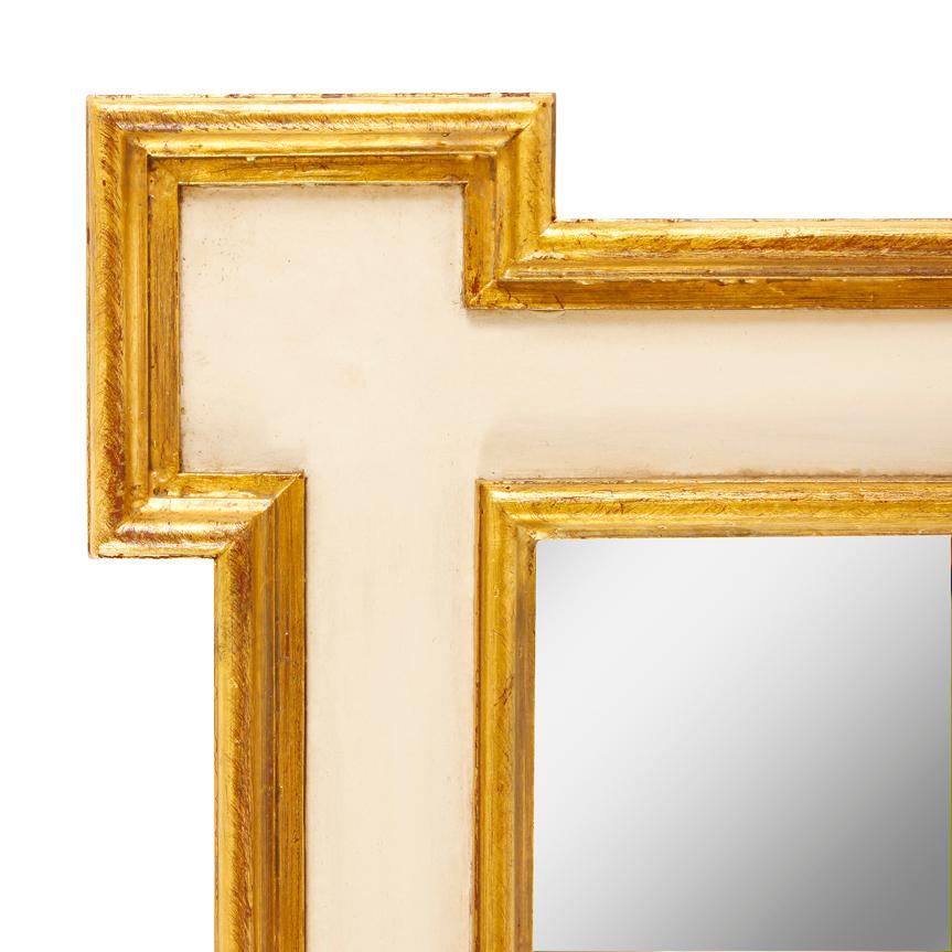 A nice looking tall mirror painted in a creamy white with gold leaf accents and inset corners.