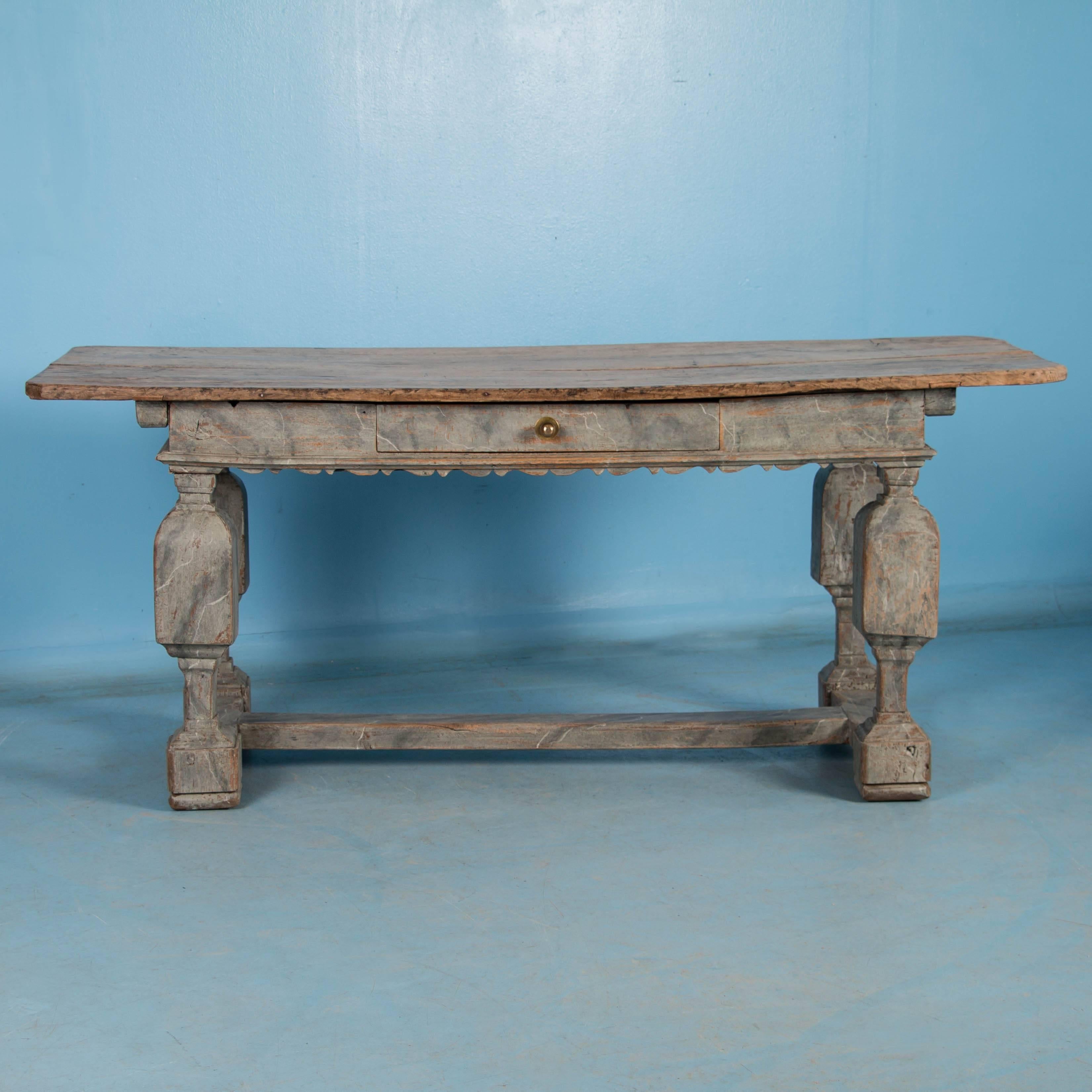 This remarkable baroque farm table maintains the grace and enduring style of over 200 years of use. The lovely grey/blue marbled paint is a traditional finish and has an amazing patina due to the wear through the years. The oak top has been left raw