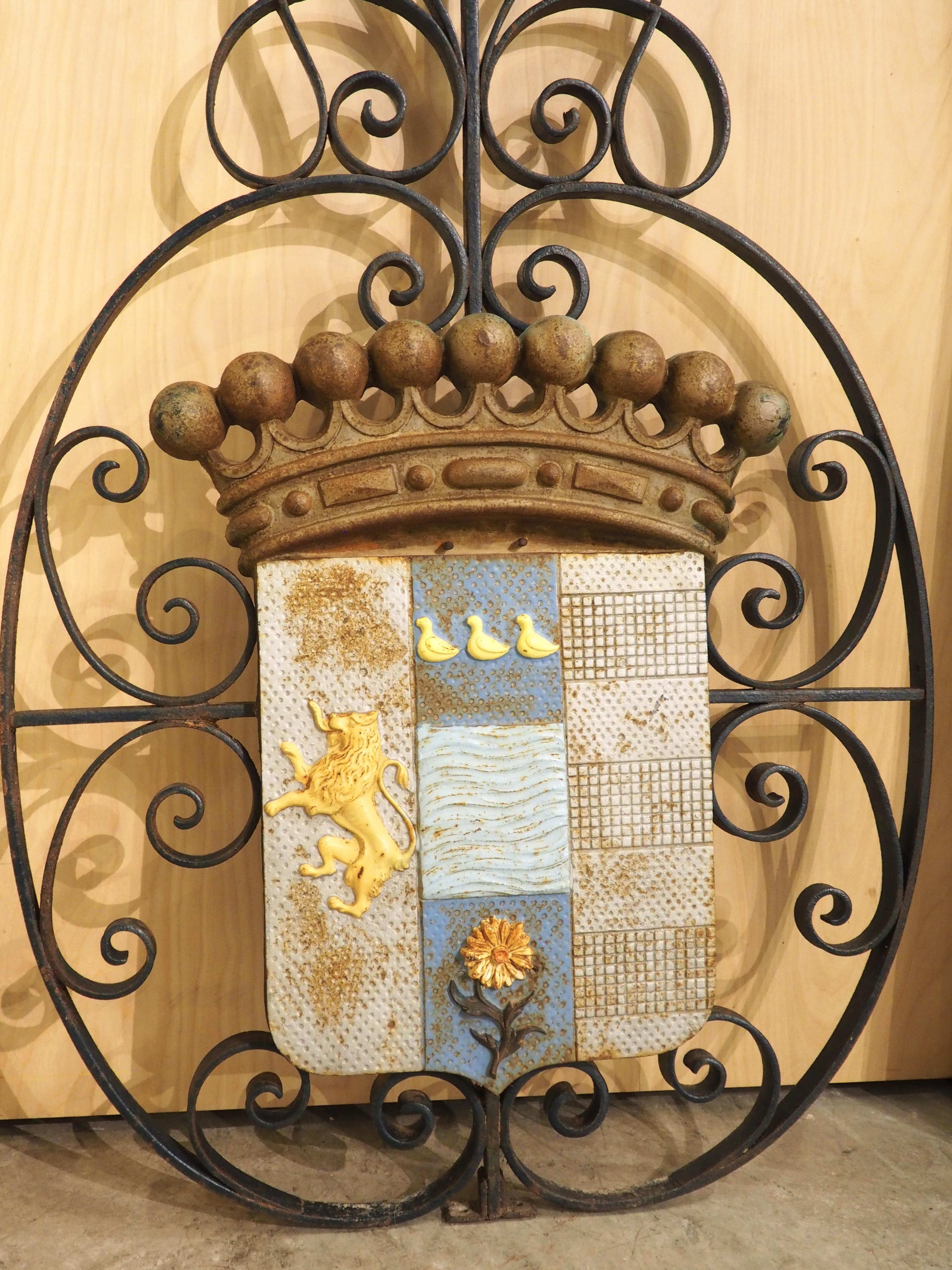 More information coming soon…

Dating to circa 1900, this French wall plaque depicts a heraldic display on top of a highly scrolled and pierced wrought iron backing.  The coat of arms is divided into three fields, depicting a family crest.  The