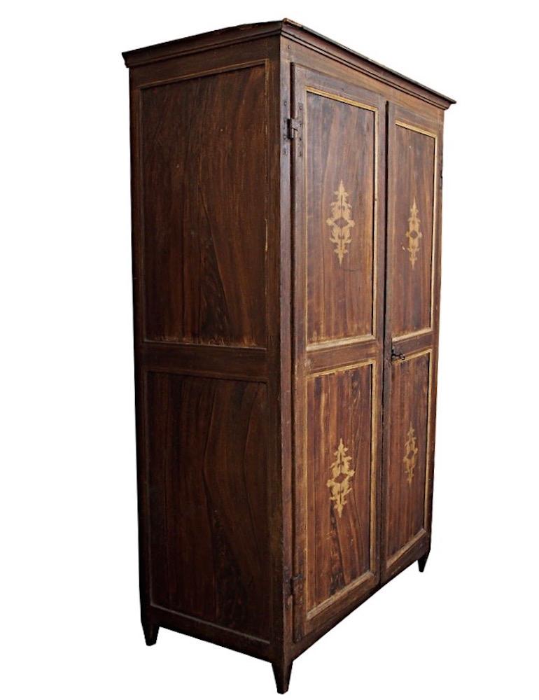 Armoire italiano Luigi XIV del XVIII secolo dipinto a due ante in faux bois con vernice decorativa neoclassica dorata. Con serratura funzionante e una chiave. Come acquistato in Italia con carta decorativa interna antica. 

Usura coerente con l'età.