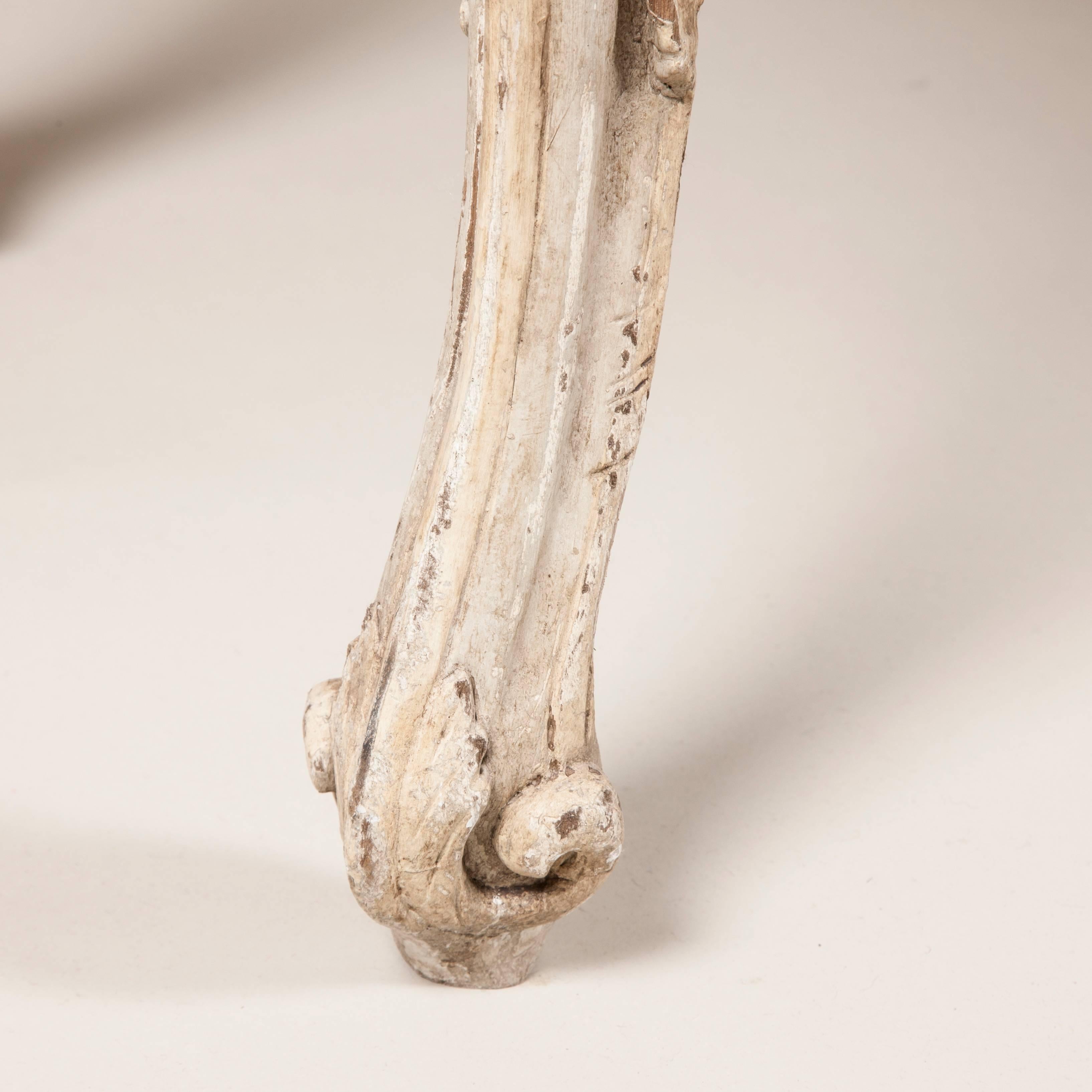 A pair of painted and carved console tables with serpentine tops and cabriole legs. Possibly French or Italian, circa 1780.