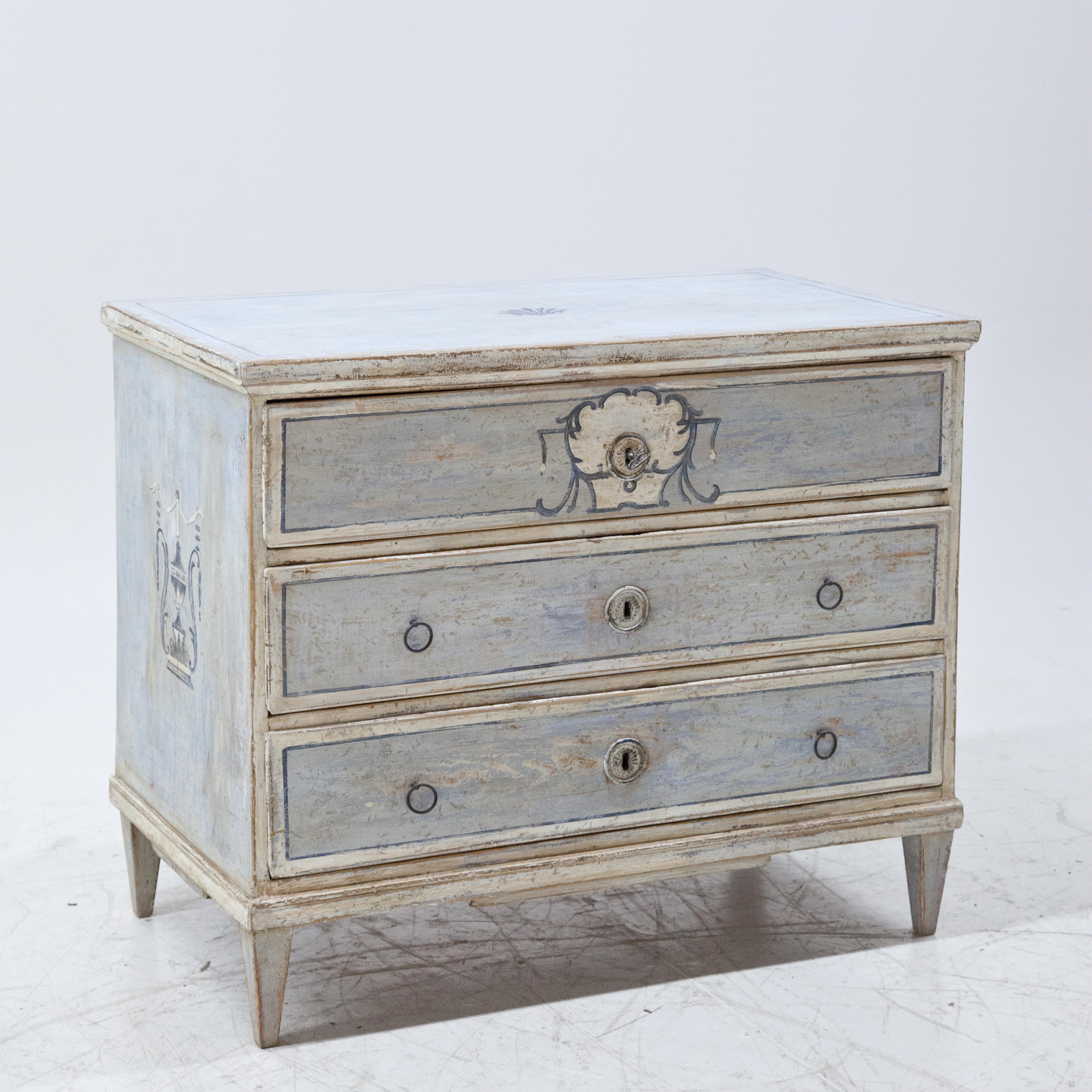 Biedermeier chest of drawers with three drawers on square pointed feet with a new, light blue paint with dark blue accents and a distressed patina.