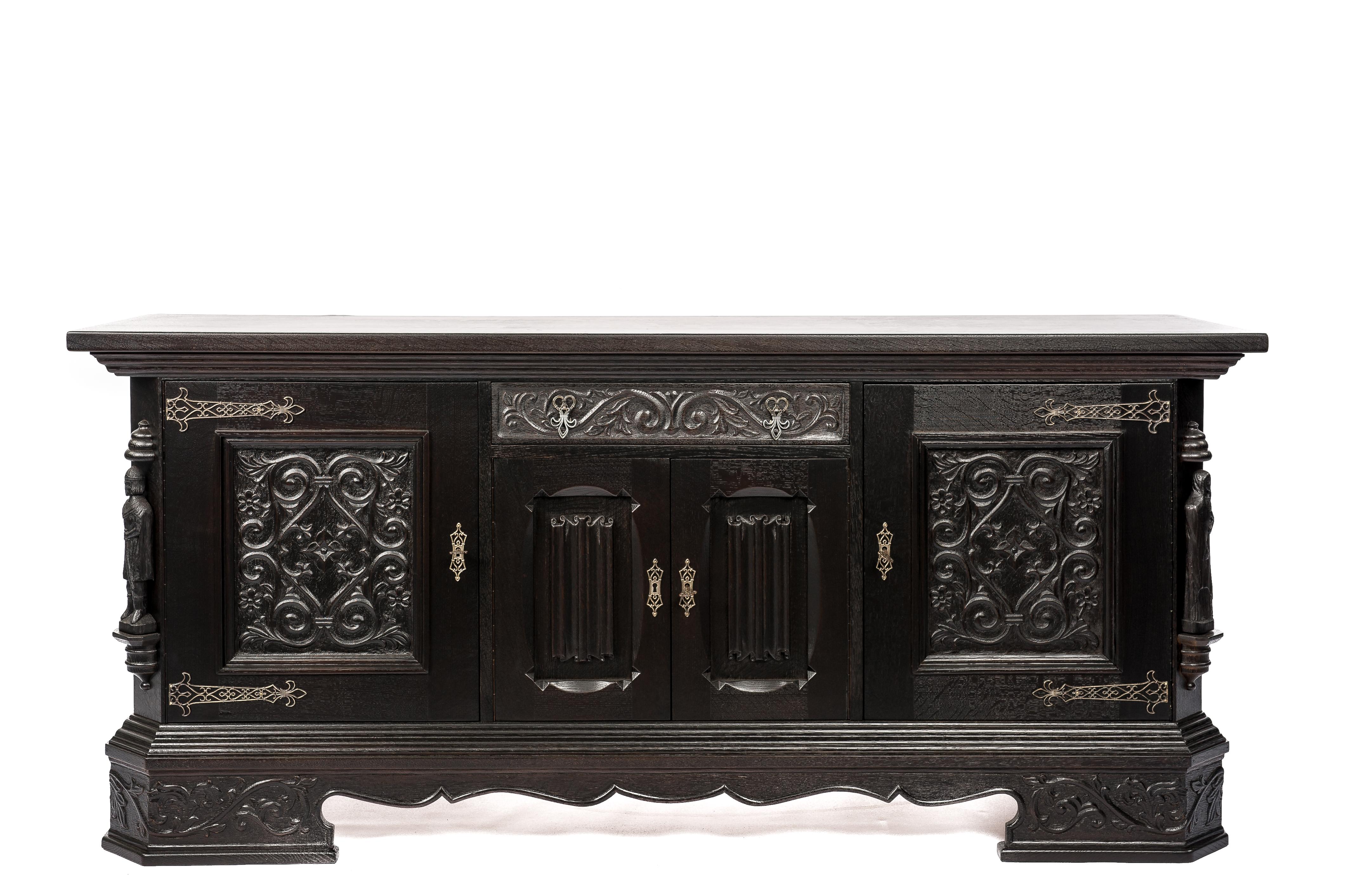 This beautiful Gothic server buffet or credenza was made in Belgium in the early 20st century. It is a well-made piece that shows great craftsmanship. The buffet is made in the finest quality European summer oak and it was adorned with hand-carved