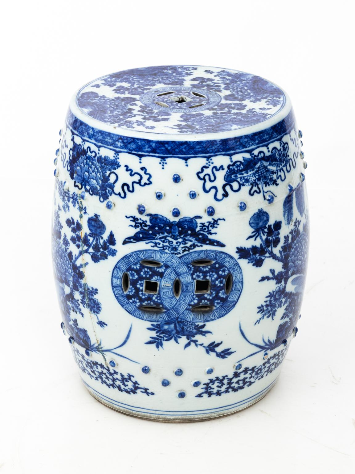 Blue and white Chinese porcelain garden seat heavily painted with birds and flowers, circa 20th century.