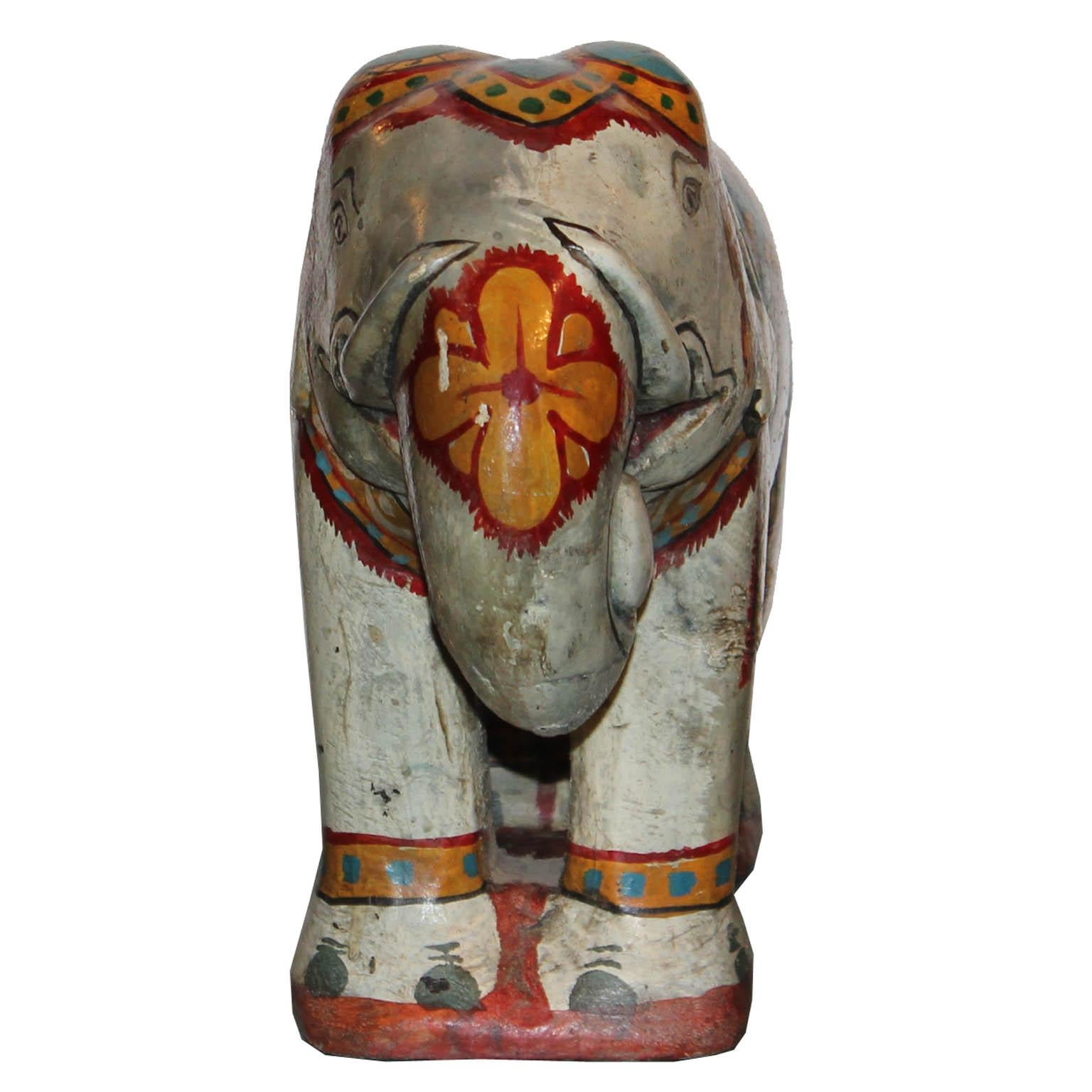 Hand painted wood elephant with regal ceremonial clothes would be a colorful accessory for a bookshelf or coffee table.