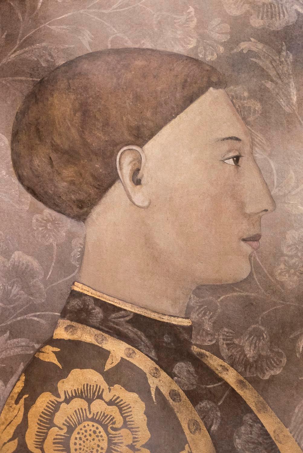 Painted canvas figuring a profile view of a man in the style of the first Italian Renaissance. He wears a gilt flower decorated suit. Brown background with white flower motifs.

Linen raw canvas hand painted with natural pigments and gilt motifs