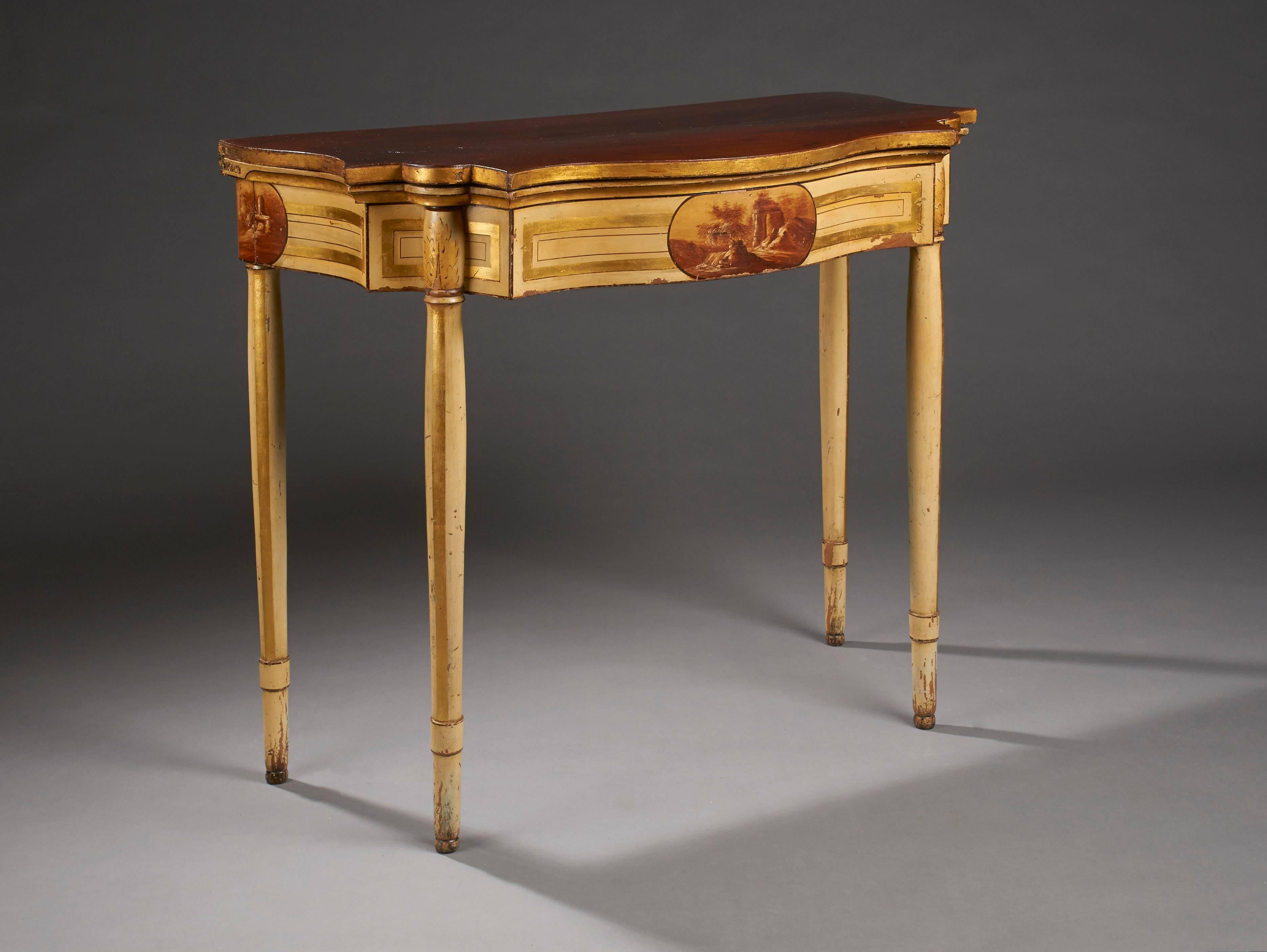 A card table from Baltimore painted with original painted and gilded classical scenes of ruins in a romantic landscape both on the front and side aprons. This example has highly developed contours with a serpentine front, half-serpentine ends and