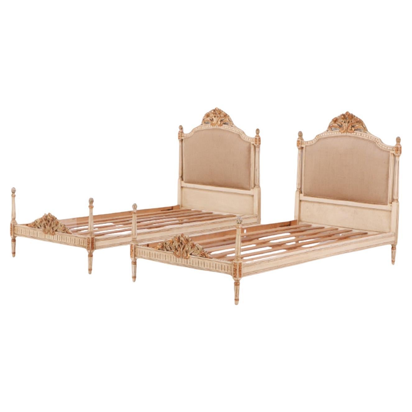 Painted, carved and gilt Louis XVI style twin size beds circa 1950. For Sale