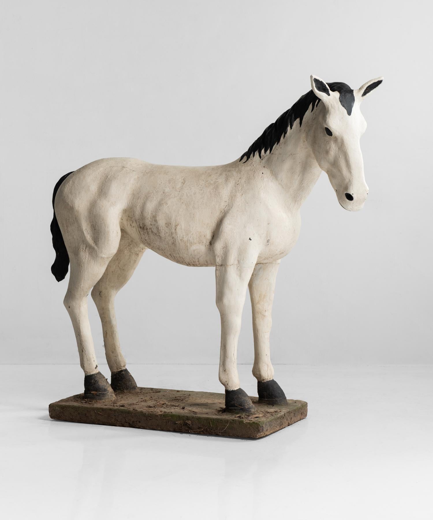 Painted cast stone horse, France, circa 1950.

Pony-size with original black and white paint and wonderful patina.