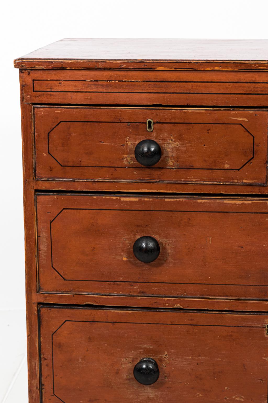 Four-drawer chest of drawers or commode on ogee shaped bracket feet in an antiqued finish, circa 1830s. The piece is also painted throughout with black trim and handles. Please note of wear consistent with age including minor surface dents and