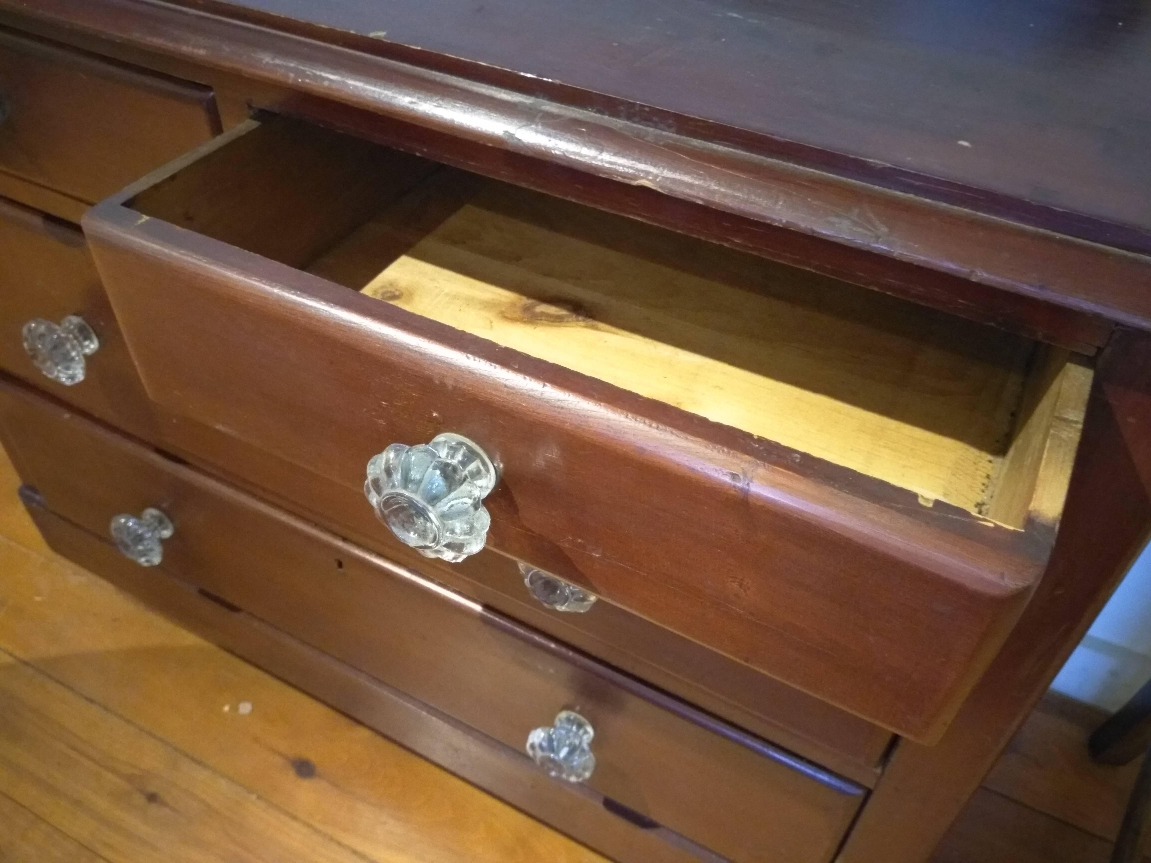 This sweet barn red chest of drawers has its original glass knobs, which makes this piece stand out immediately. Made in England, it dates from 1880 and is made of pine. It is in very nice condition and a small piece which would be perfect for a