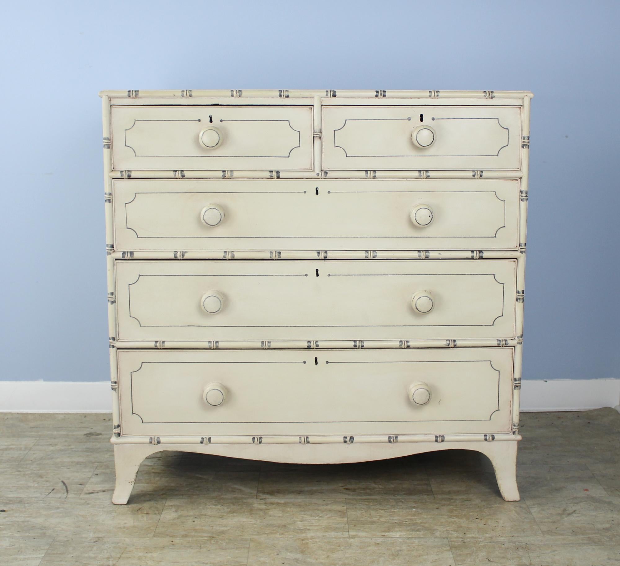 A charming Regency chest of drawers with bamboo detail, newly painted in an antique cream with small areas of faux distress. Perfectly suited to a beach cottage, child's room or guest room. Roomy drawers open and shut easily. Painted over original
