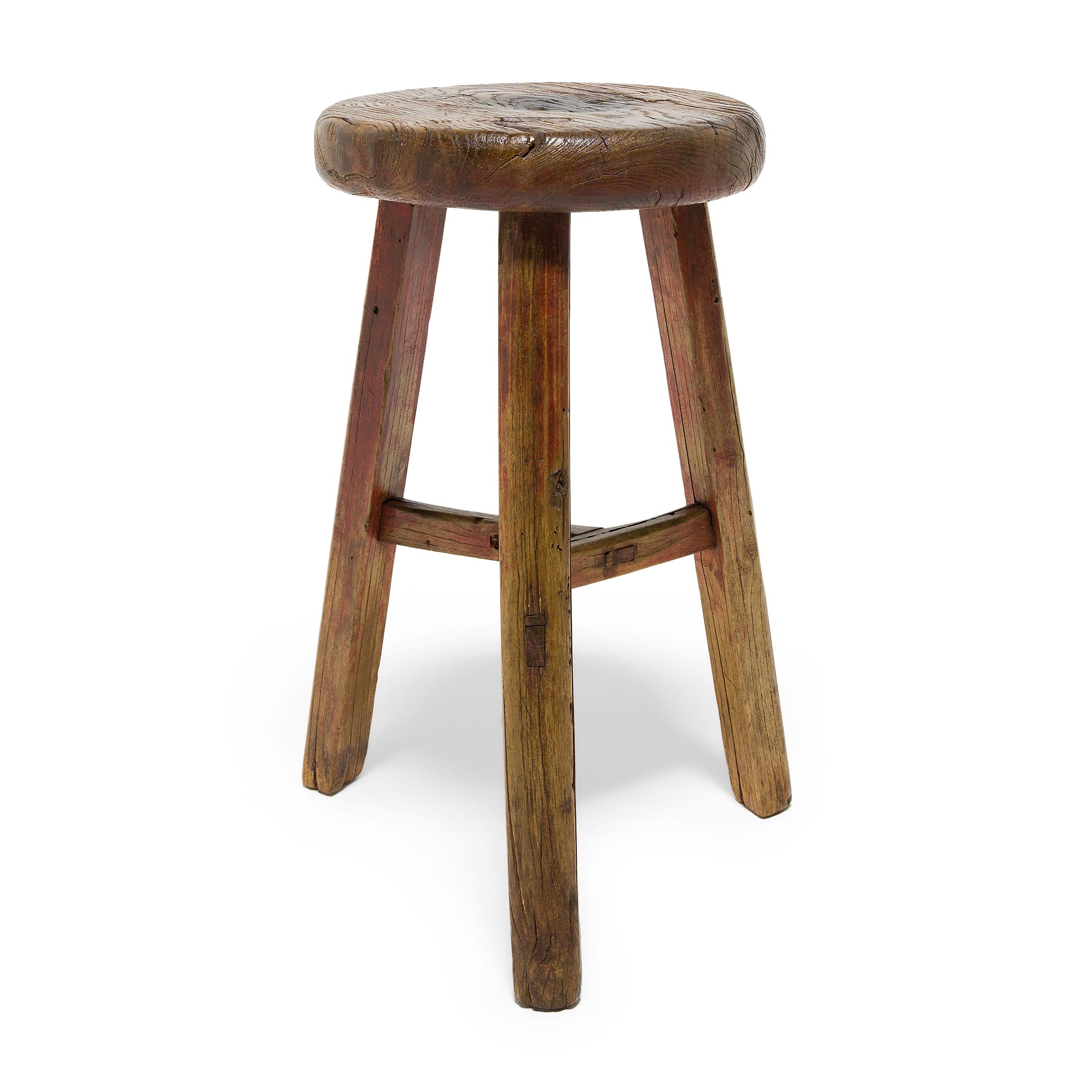 Deceptively simple, this early 20th century stool from Shanxi province shows off the ingenious joinery methods traditionally used by Chinese carpenters. The stool's three splayed legs are supported by stretcher bars that interlock at the center in a