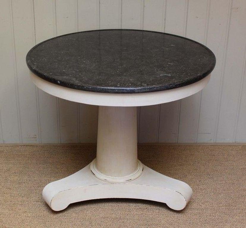 Painted central table having a substantial pedestal painted base with a polished granite top.
