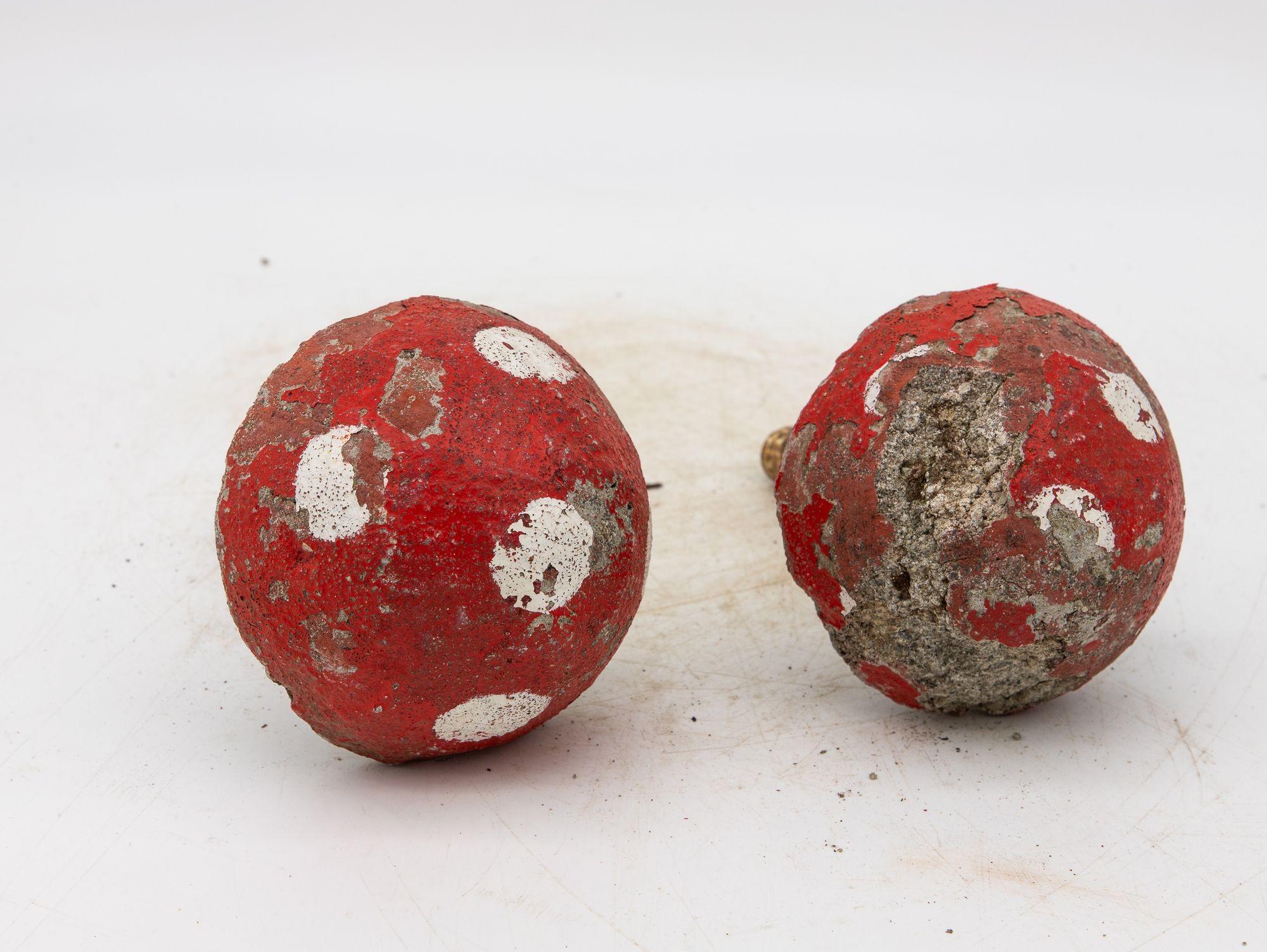 Weather-worn and full of charm, this whimsical pair of red-and-white mushroom statues adds playful nostalgia to any garden. Each concrete piece features a traditional white stem, bright red cap with white spots, and a iron stake, all offering a