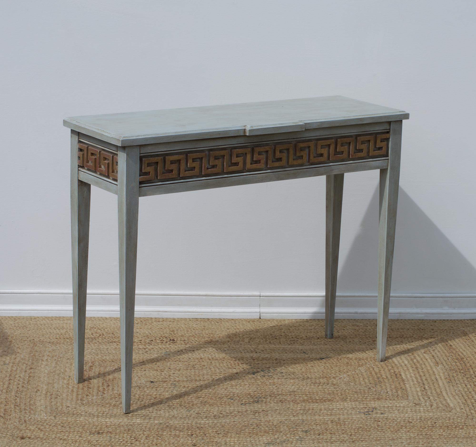A smart looking console table having neoclassical bones and a fetching Greek key paneled and gilt detail. Each table is bench made by hand in Virginia and constructed with pride. The custom and modular table can be ordered to your exact size and