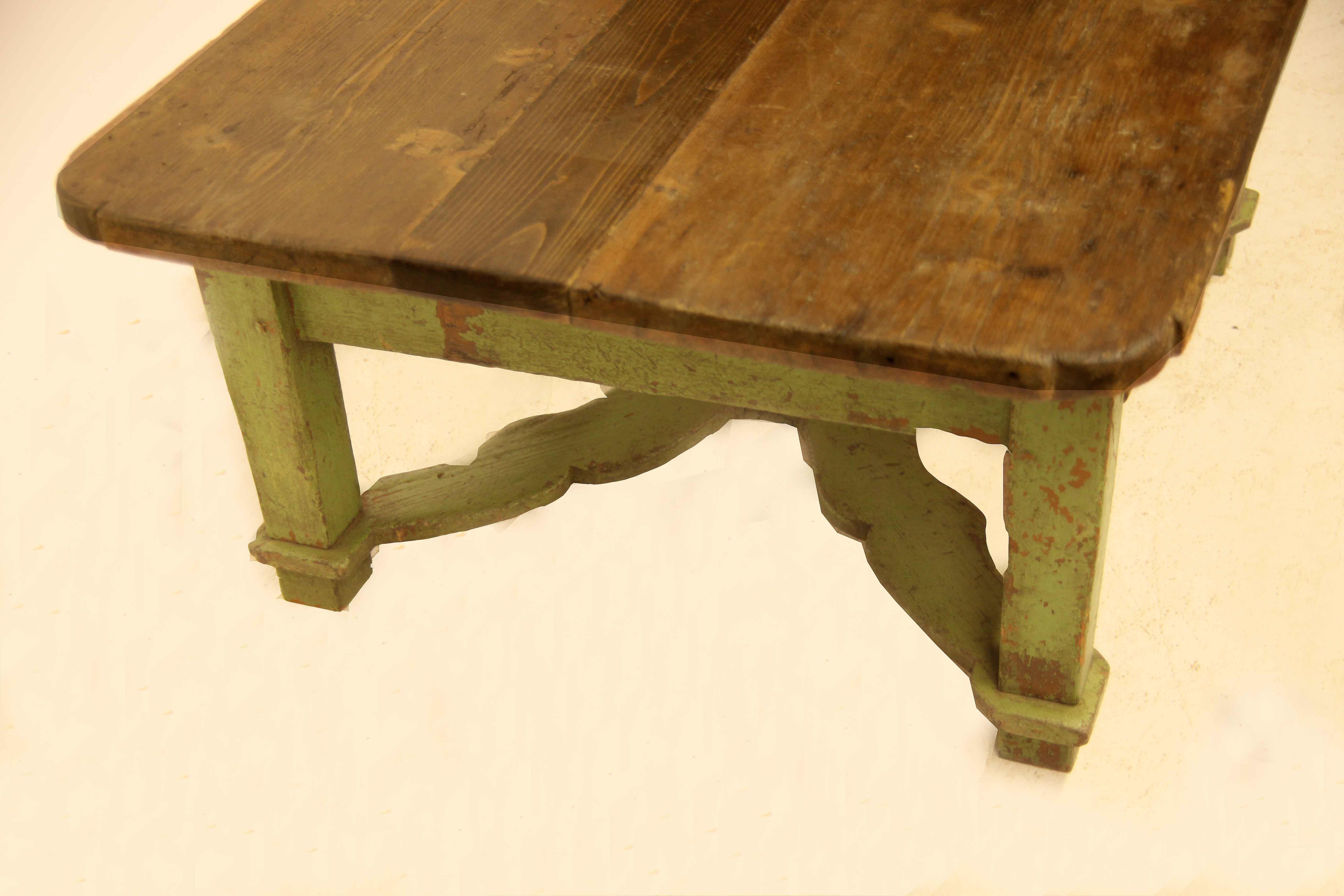Painted pine Continental coffee table, the scrub top with rounded corners has a wax finish, single drawer with steel ring pulls. The tapered legs have a connecting ''x'' stretcher with a turned finial in the center. The top is made to slide forward