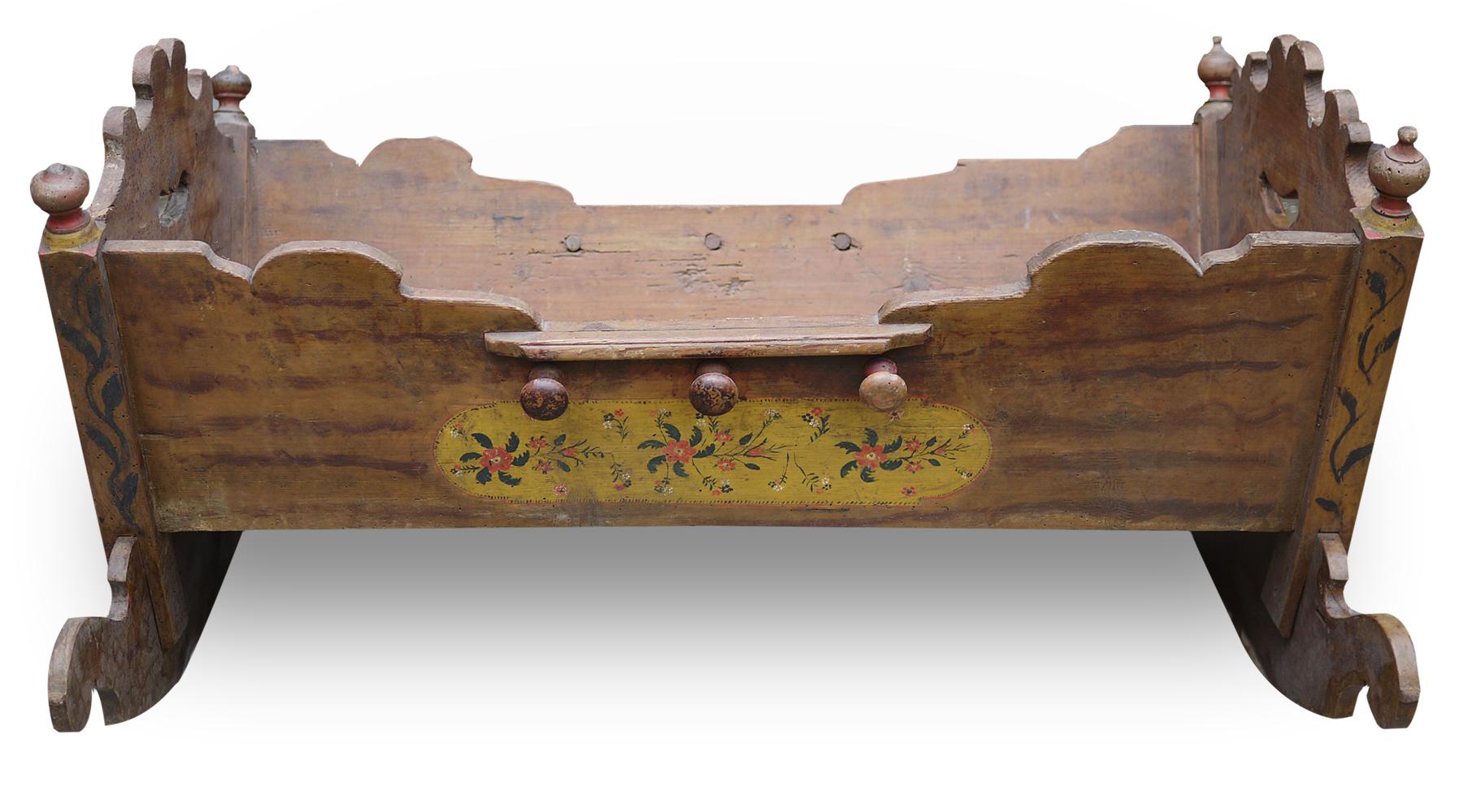 Rare original old painted Alpine cradle

Measures: H. 55cm, L. 90cm, P. 70cm

On the whole surface there are floral decorations and apotropaic symbols. At the ends, two medallions are painted, one depicting the Madonna and Child, the other the