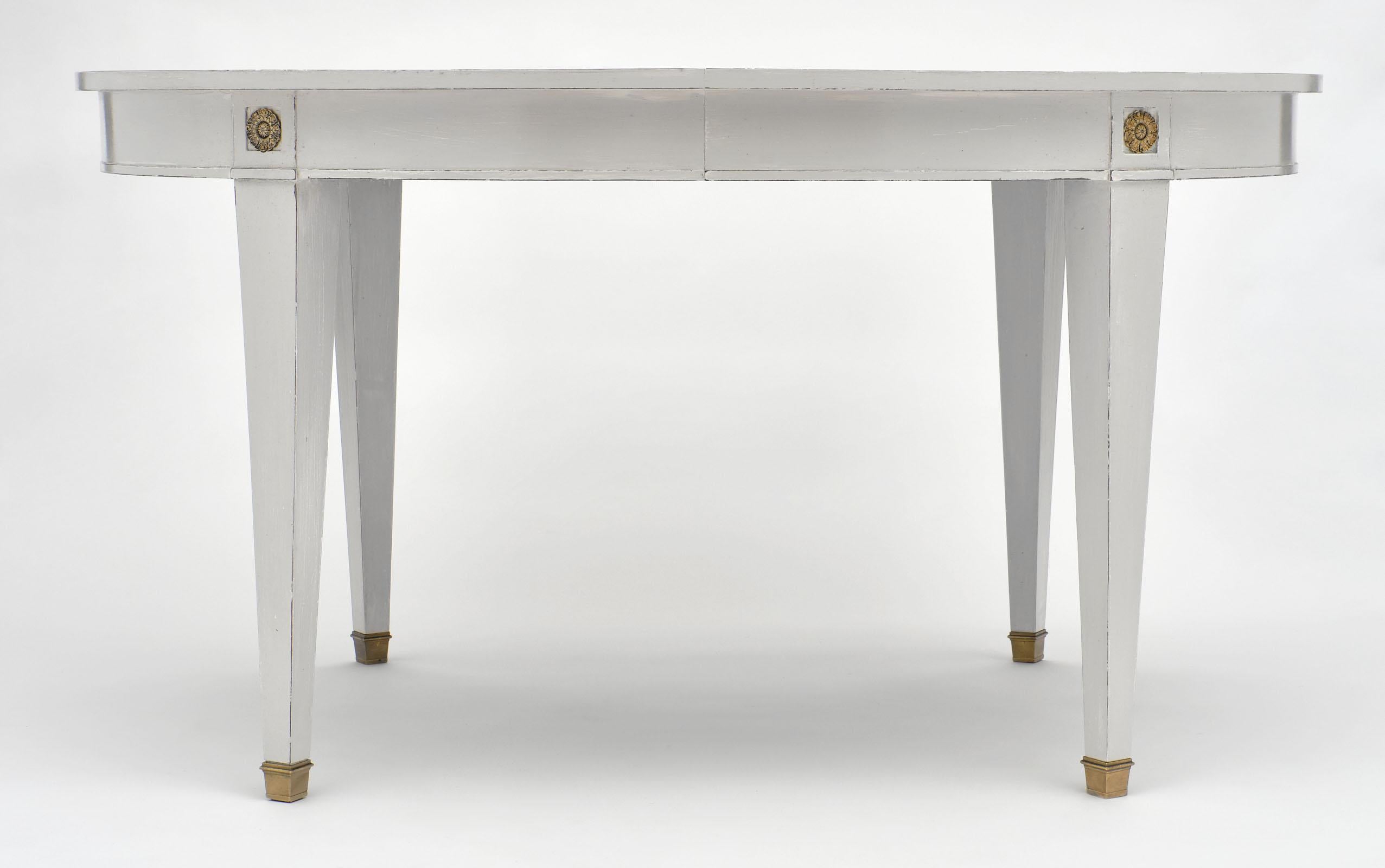 Directoire style painted dining table featuring beautiful brass feet and hardware. We love the classic details and strong lines of this table!