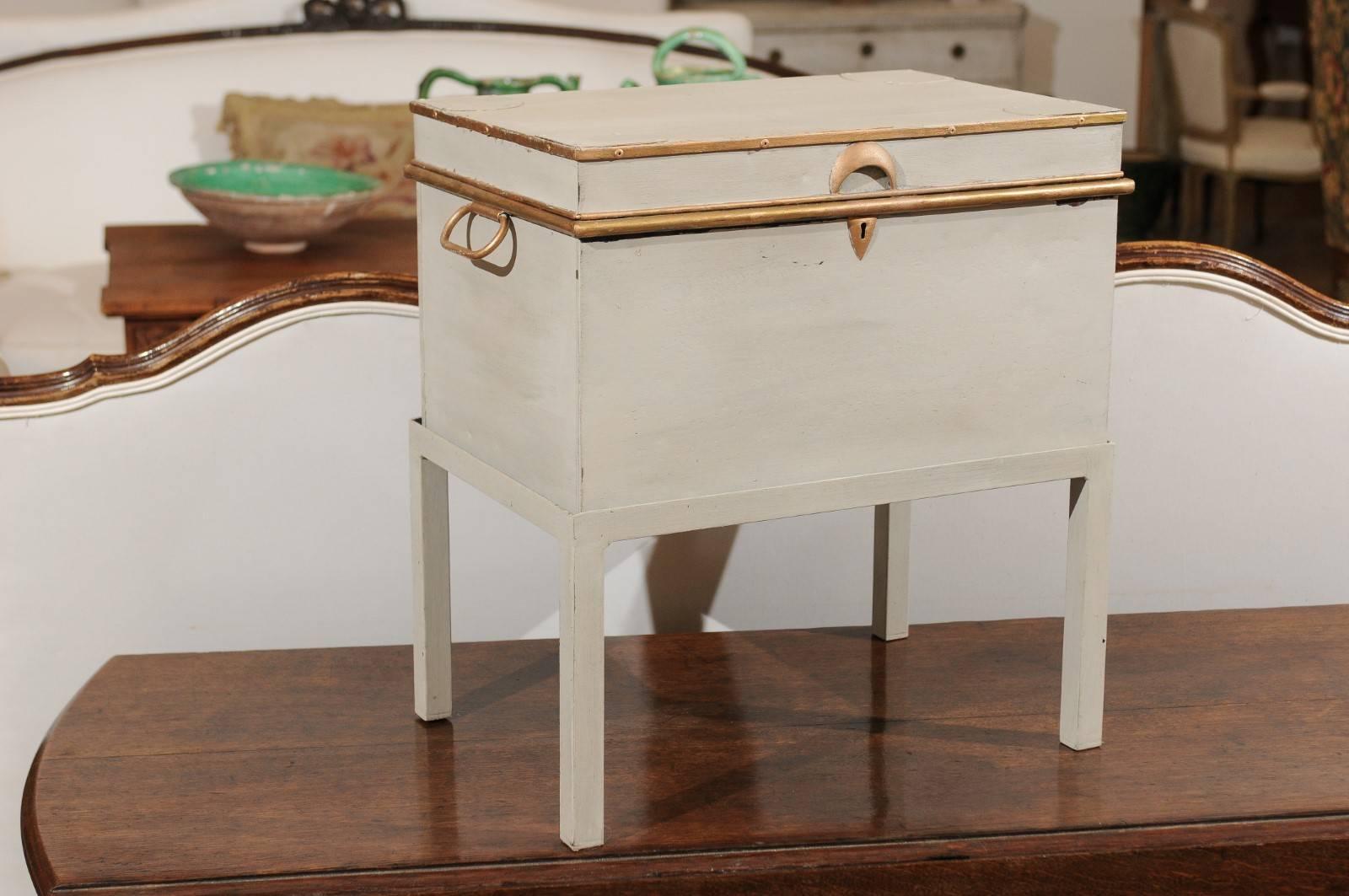 A French 19th century painted and giltwood letter box raised on custom stand, perfect to be used as a drink table. This French drink table is made of a 19th century letter box, painted in a soft color and accented with gilded details, such as the