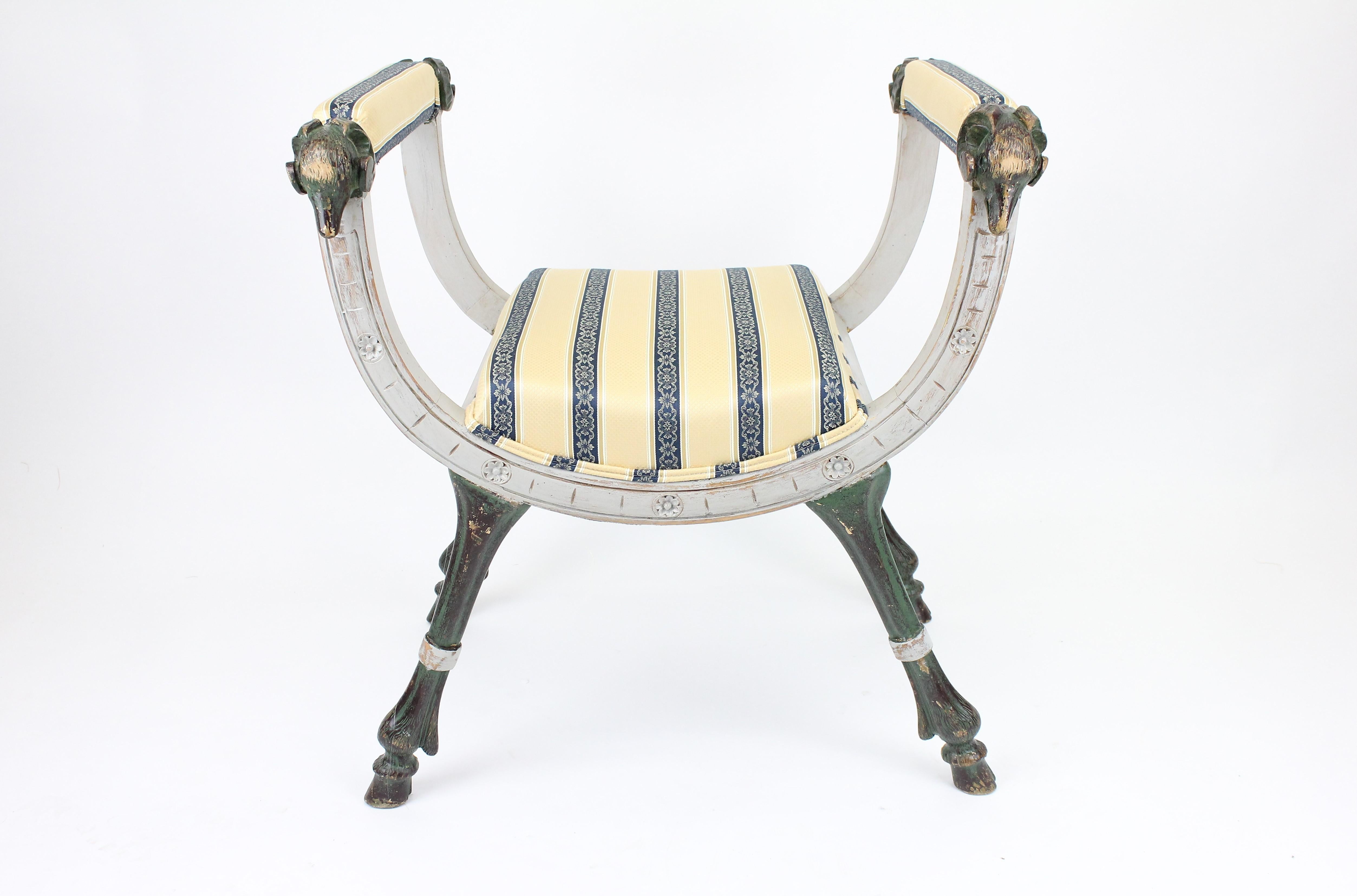 Very stylish stool/bench or banquette.
Late 19th Century. Painted wood and recently reupholstered.
With wood-carved Rams heads and hoof feat.
Painted wood in gray, green, and some black.

See the images for how this looked before it was